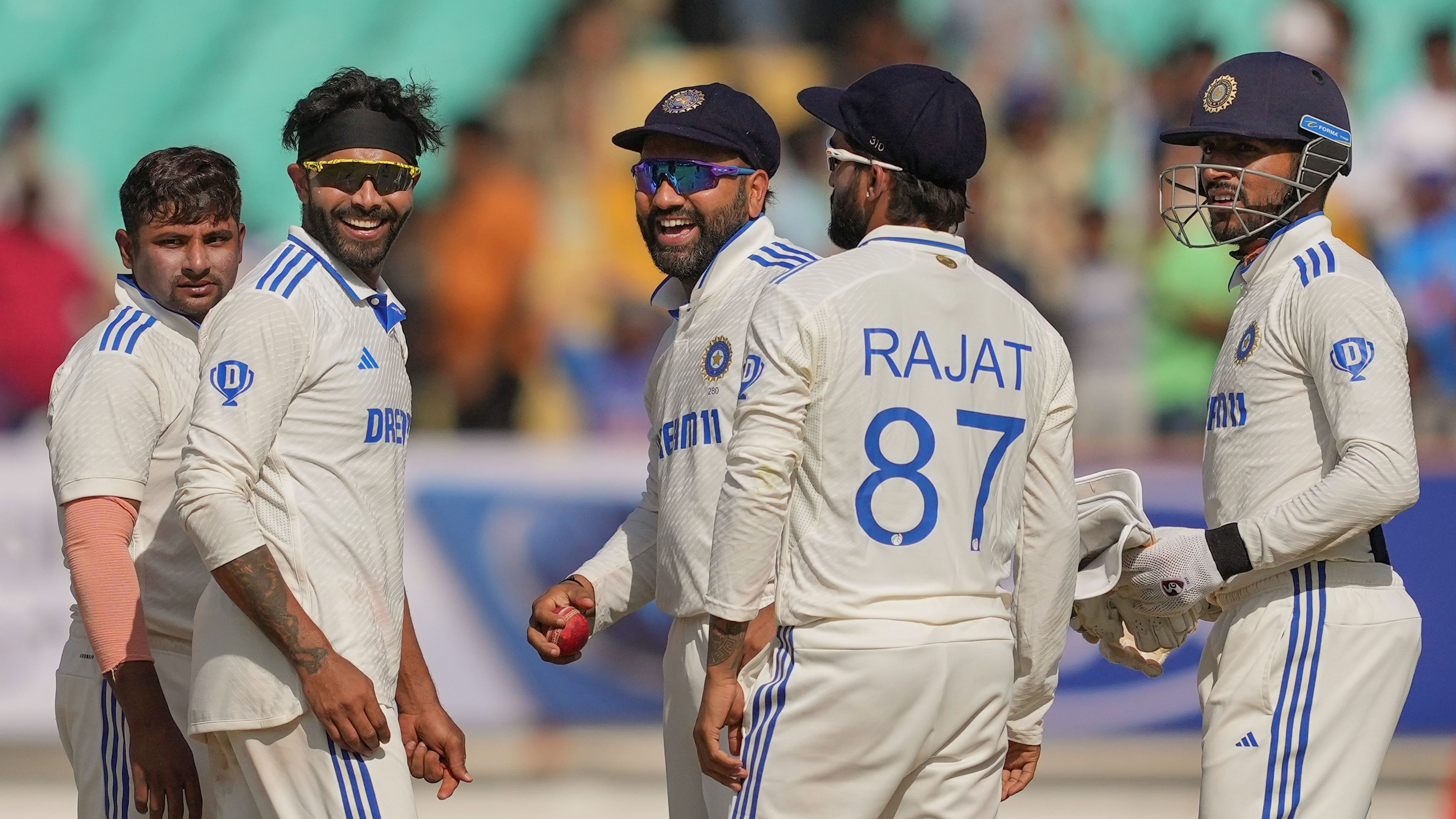 <div class="paragraphs"><p> India's Ravindra Jadeja celebrates with captain Rohit Sharma and others after taking the wicket of England's Joe Root on the fourth day of the third Test cricket match between India and England, at the Niranjan Shah Stadium, in Rajkot.</p></div>