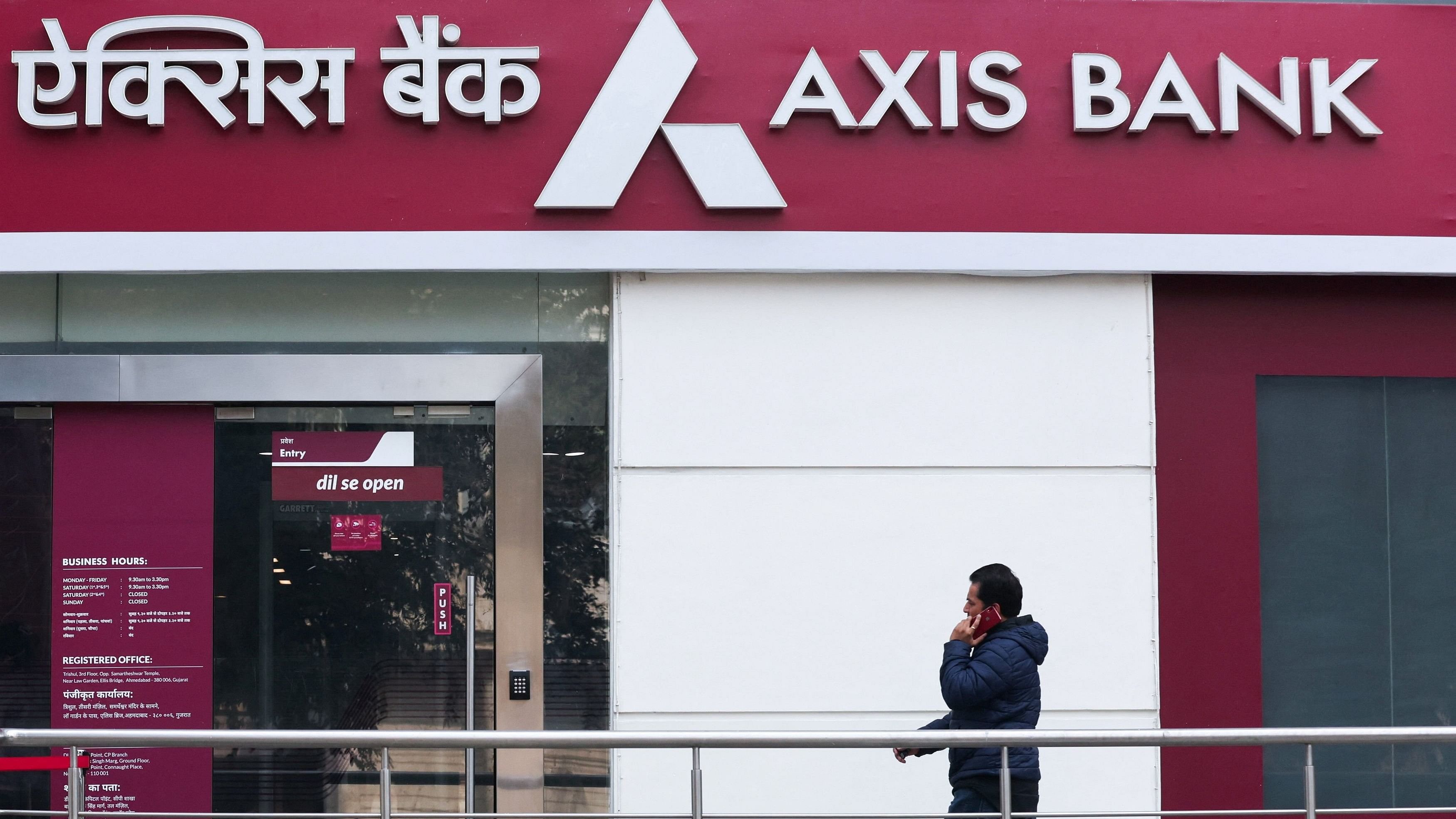 <div class="paragraphs"><p>A man walks outside a branch of Axis Bank.</p></div>