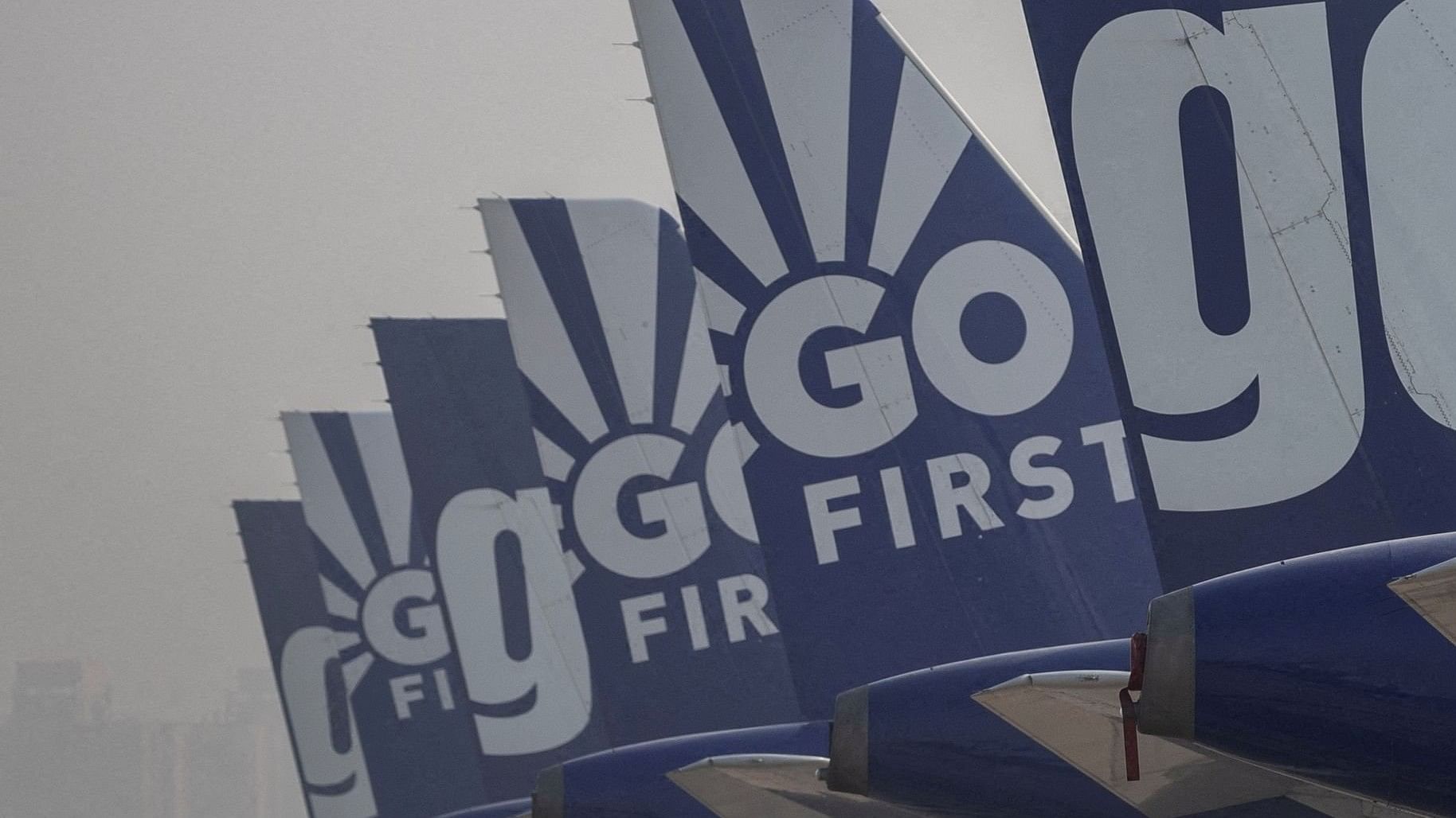 <div class="paragraphs"><p>The tail fins of Go First airline's passenger aircrafts parked on the tarmac at the airport in New Delhi.</p></div>