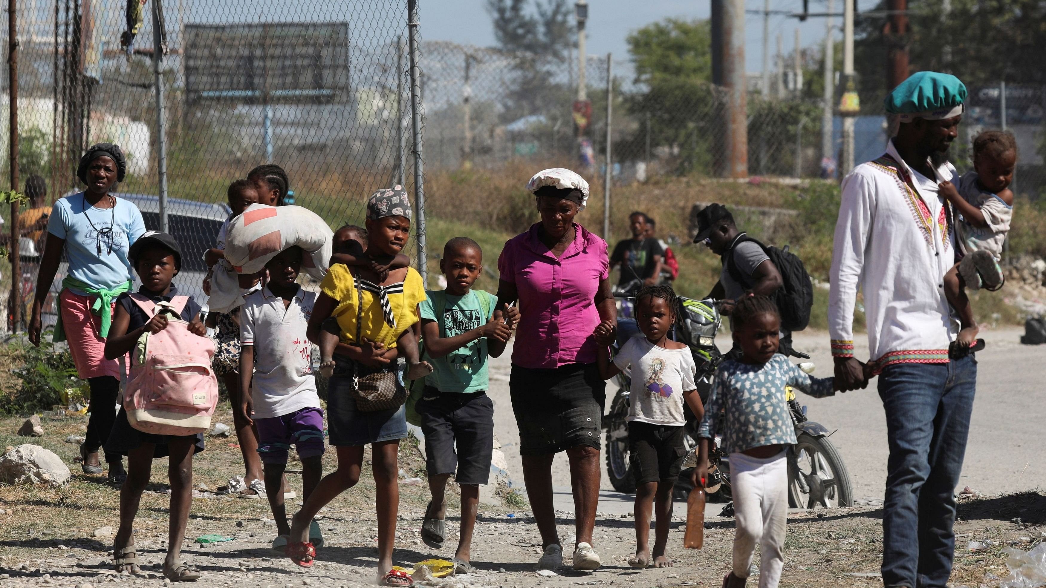 <div class="paragraphs"><p>People fleeing violence arrive at a Haitian National Police station, following a shootout between rival gangs, in Port-au-Prince, Haiti.</p></div>