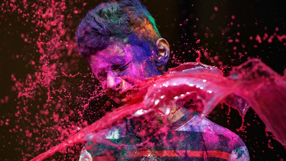 <div class="paragraphs"><p>A reveller is splashed with colour water during 'Holi' celebrations. </p></div>