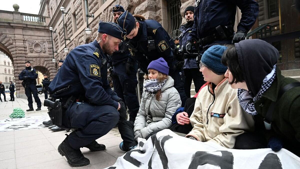 <div class="paragraphs"><p>Police officers gather next to Greta Thunberg as she demonstrates outside the Swedish Parliament building together with a group of climate activists in Stockholm, Sweden on March 13, 2024.</p></div>