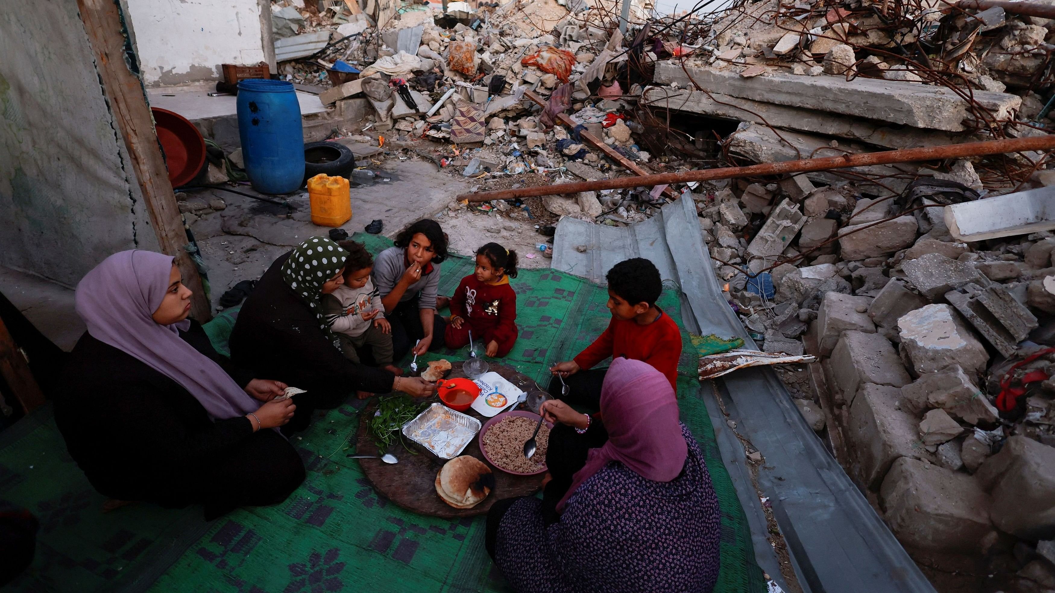 <div class="paragraphs"><p>Palestinians break their fast amid the rubble of their destroyed home during the Muslim holy fasting month of Ramadan, as the conflict between Israel and Hamas continues, in Rafah, in the southern Gaza Strip March 13, 2024. </p></div>