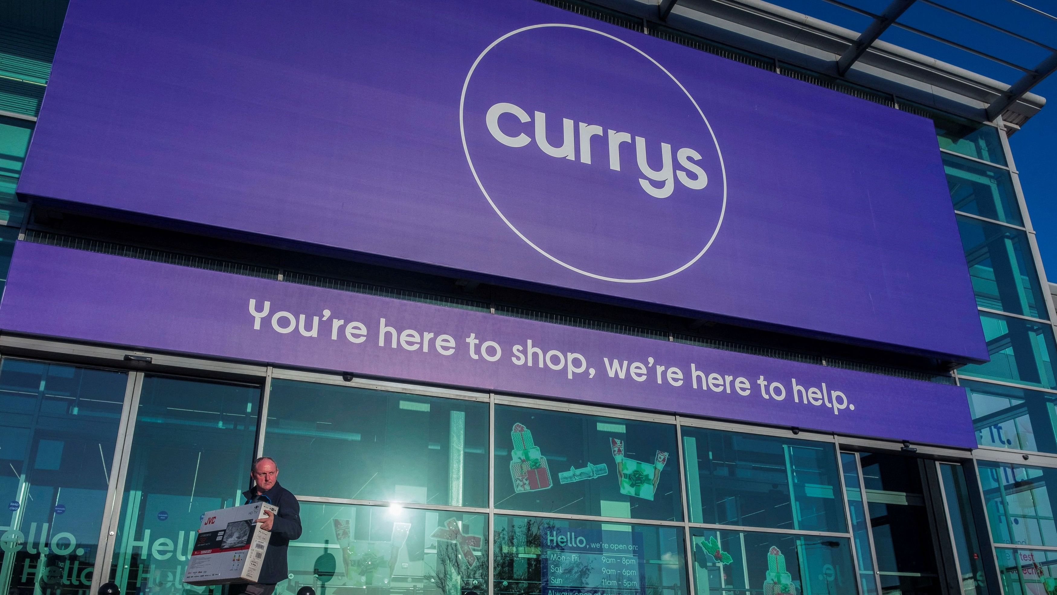 <div class="paragraphs"><p>A file photo of a&nbsp;person carring a television outside a Currys store in London.</p></div>