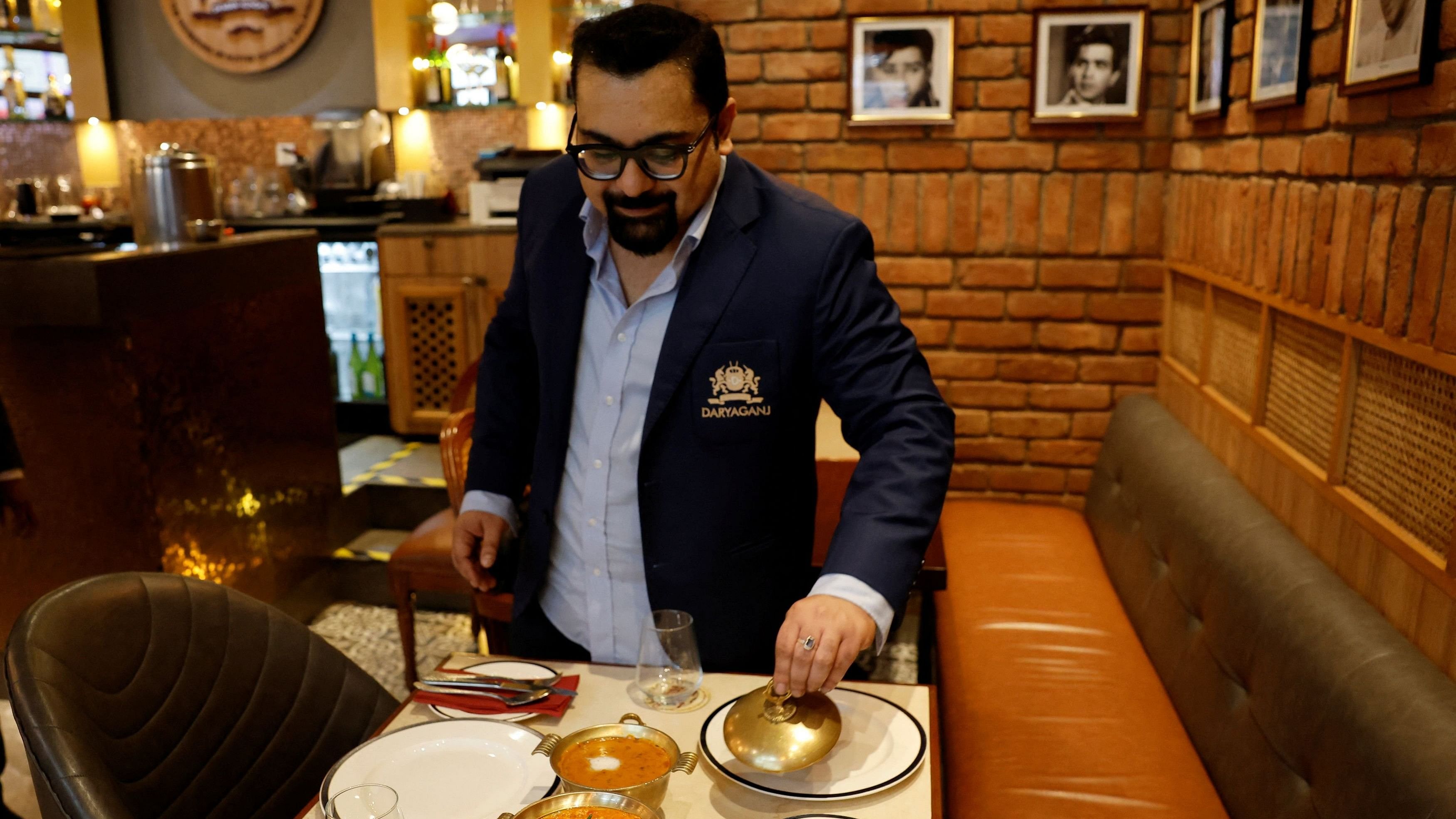 <div class="paragraphs"><p>Amit Bagga, CEO of Daryaganj restaurant, shows a freshly prepared butter chicken dish and the lentil dish Dal Makhani inside Daryaganj restaurant at a mall, in Noida, India, January 23, 2024.</p></div>