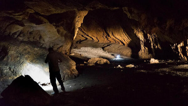 <div class="paragraphs"><p>A person stands in Pebdeh Cave, in the southern Zagros Mountains, Iran, in this undated photo obtained by Reuters on March 25, 2024. Pebdeh Cave was occupied by hunter-gatherers as early as 42,000 years ago, inferred to be Homo Sapiens.</p></div>