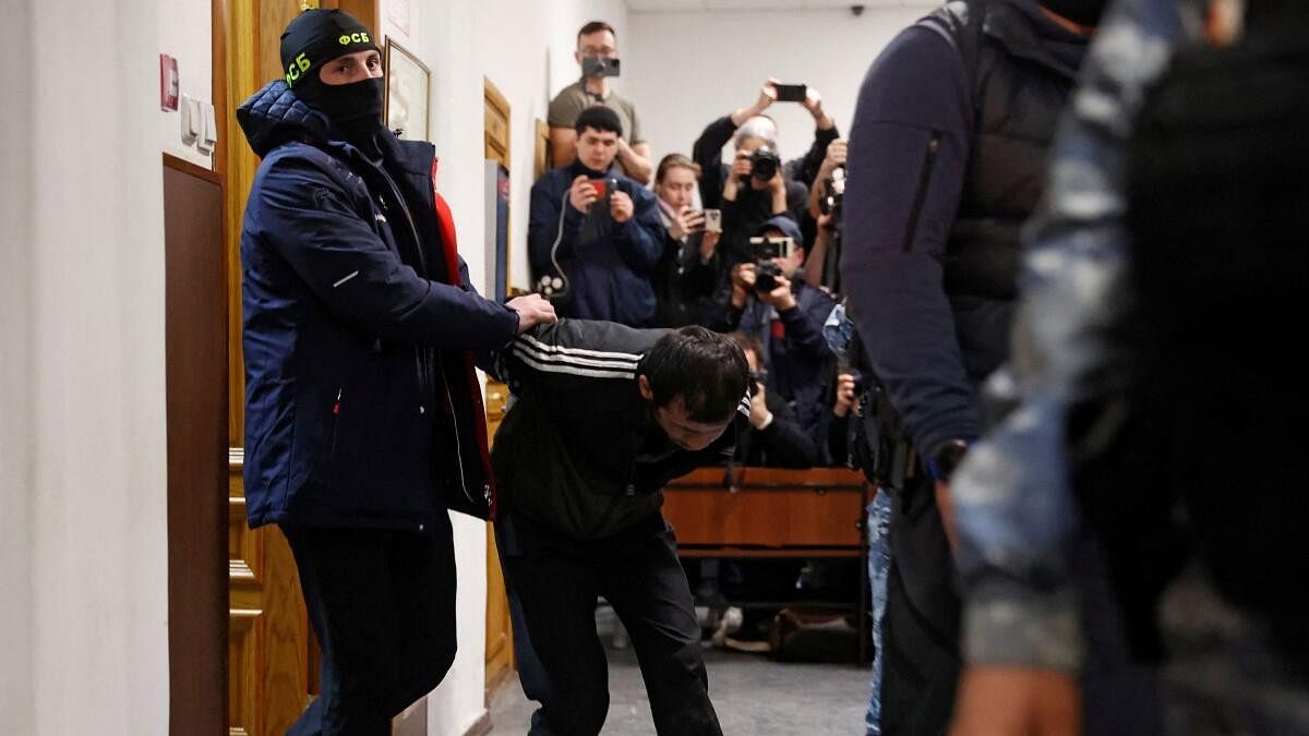 <div class="paragraphs"><p>A suspect in the shooting attack at the Crocus City Hall concert venue, is escorted before a court hearing at the Basmanny district court in Moscow.</p></div>