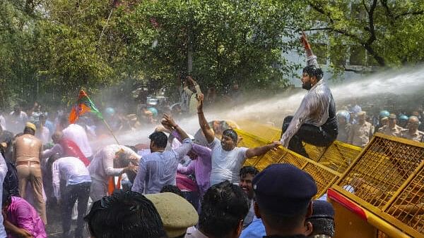 <div class="paragraphs"><p>Security personnel use water cannon to disperse BJP workers during their protest demanding the resignation of Delhi Chief Minister Arvind Kejriwal.</p></div>