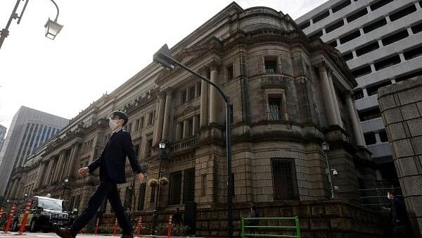 <div class="paragraphs"><p>A man walks in front of the headquarters of Bank of Japan in Tokyo, Japan.</p></div>