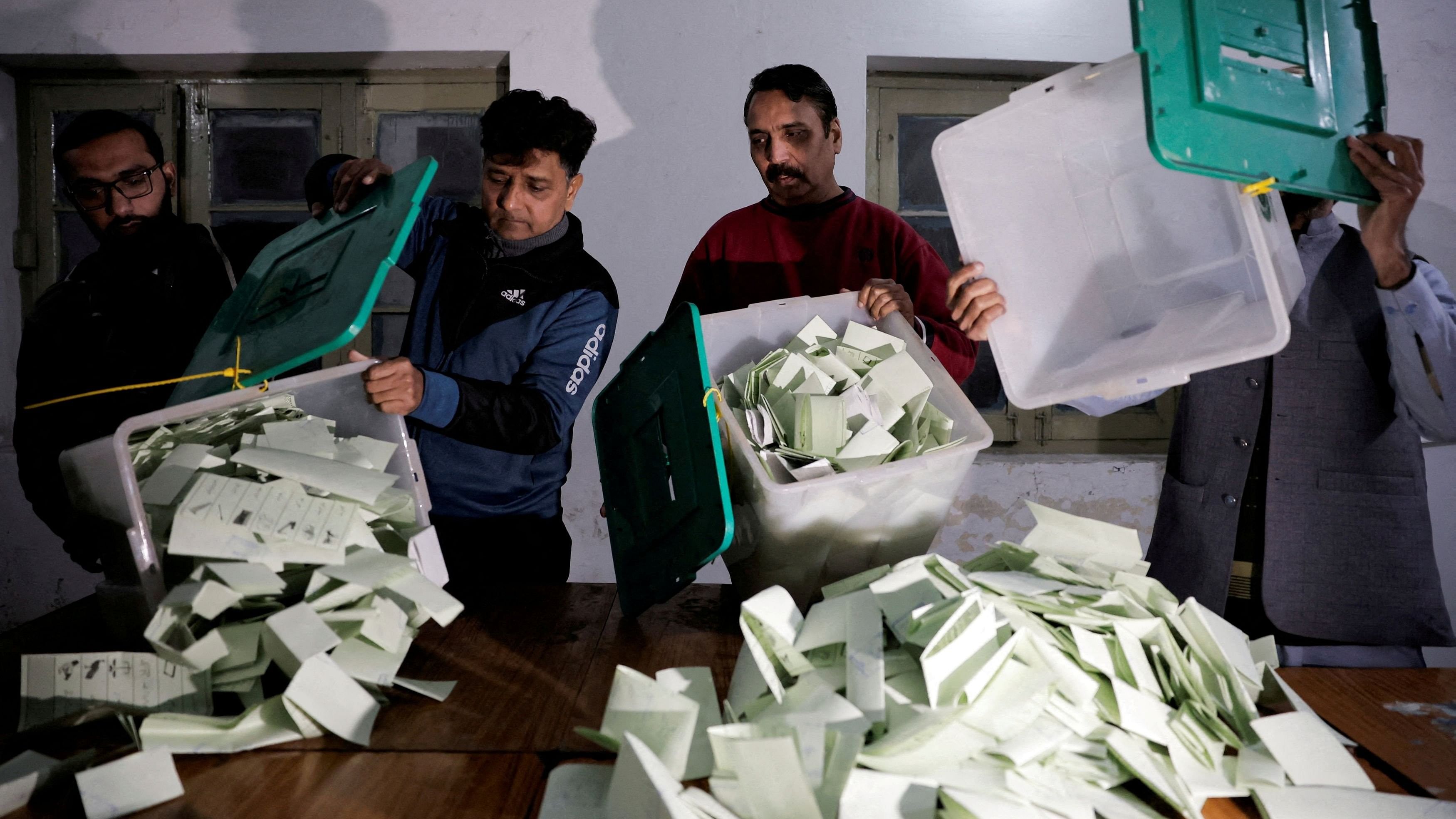 <div class="paragraphs"><p>Polling staff empty a ballot box after polls closed at a polling station during the general election, in Lahore, Pakistan, February 8, 2024.</p></div>