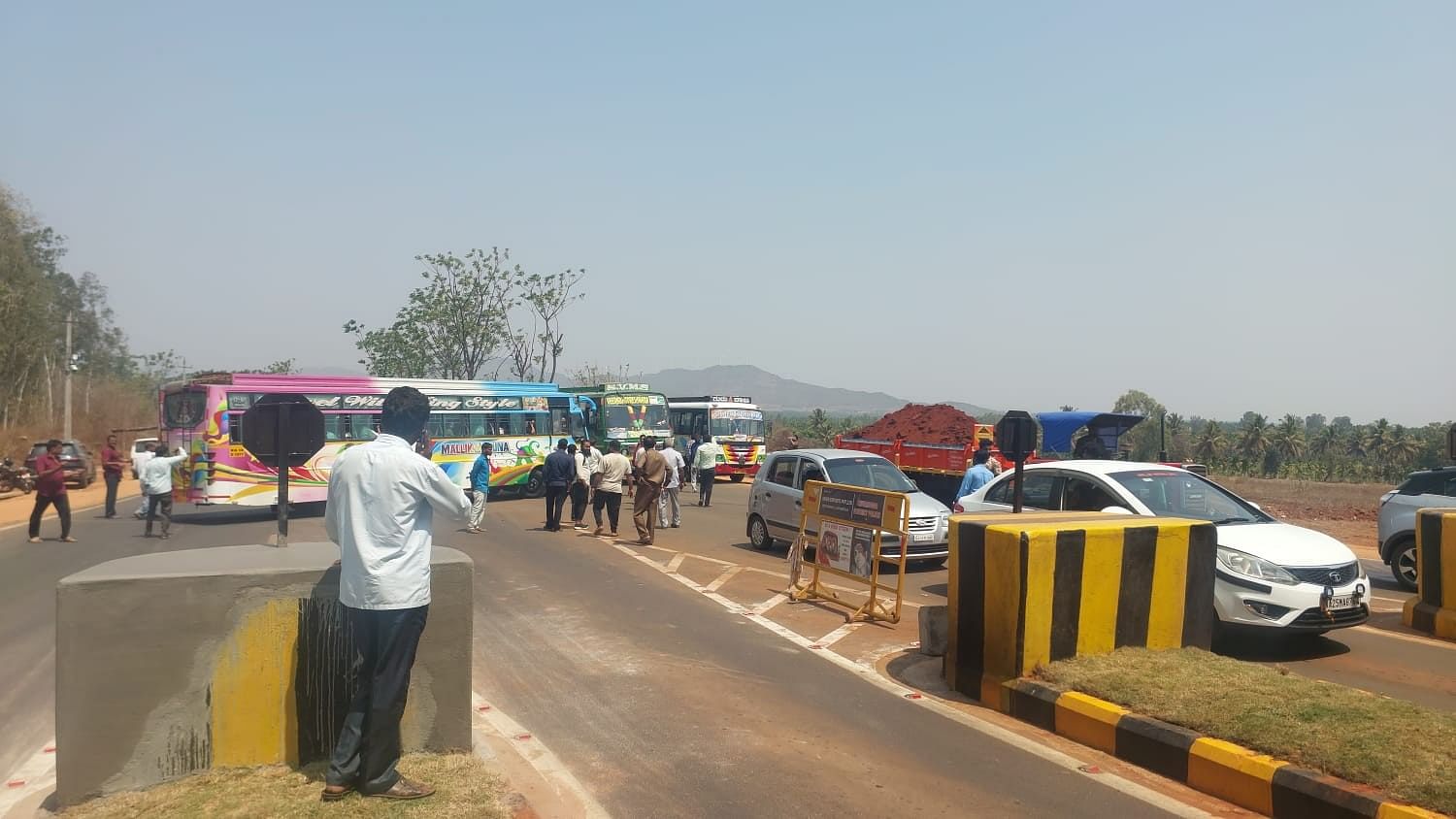 <div class="paragraphs"><p>Private bus operators blocked the highway near the new toll gate that's built on Savalanga road, in Shivamogga on Tuesday, March 19, 2024.</p></div>