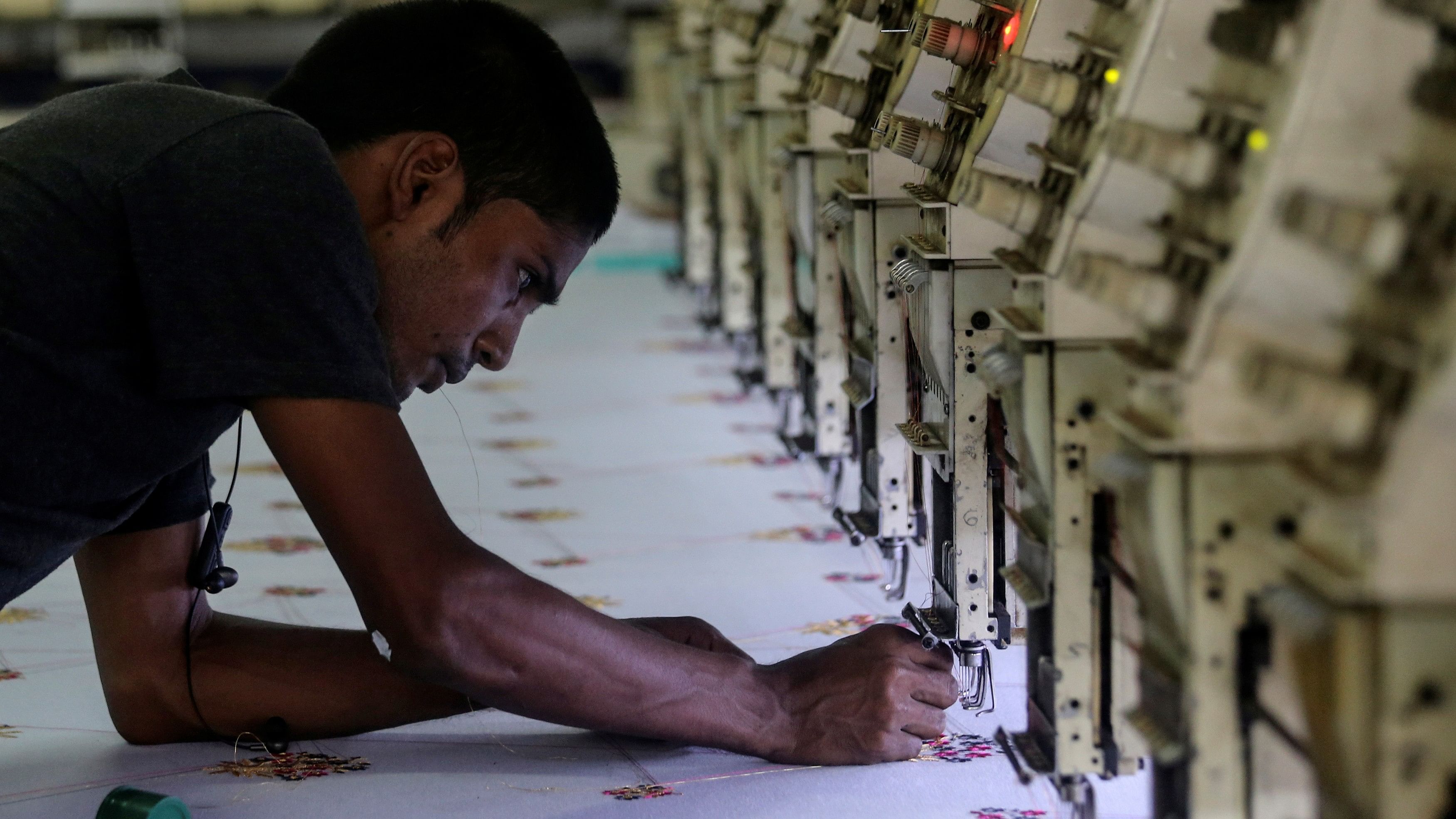 <div class="paragraphs"><p>A worker adjusts the thread on an embroidery machine at a workshop in Mumbai. (Representative image)</p></div>