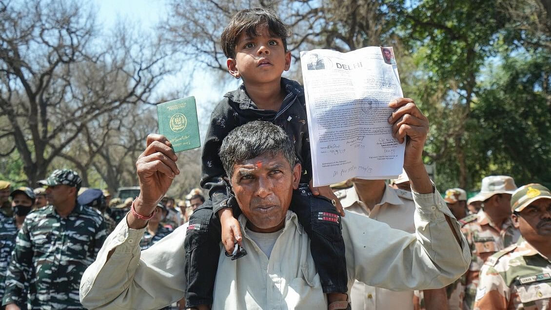 <div class="paragraphs"><p>A refugee from Pakistan shows his passport and other documents during a protest by Hindu and Sikh refugees from Pakistan and Afghanistan at AICC headquarters over statements made by the INDIA opposition bloc leaders on the Citizenship (Amendment) Act (CAA).</p></div>