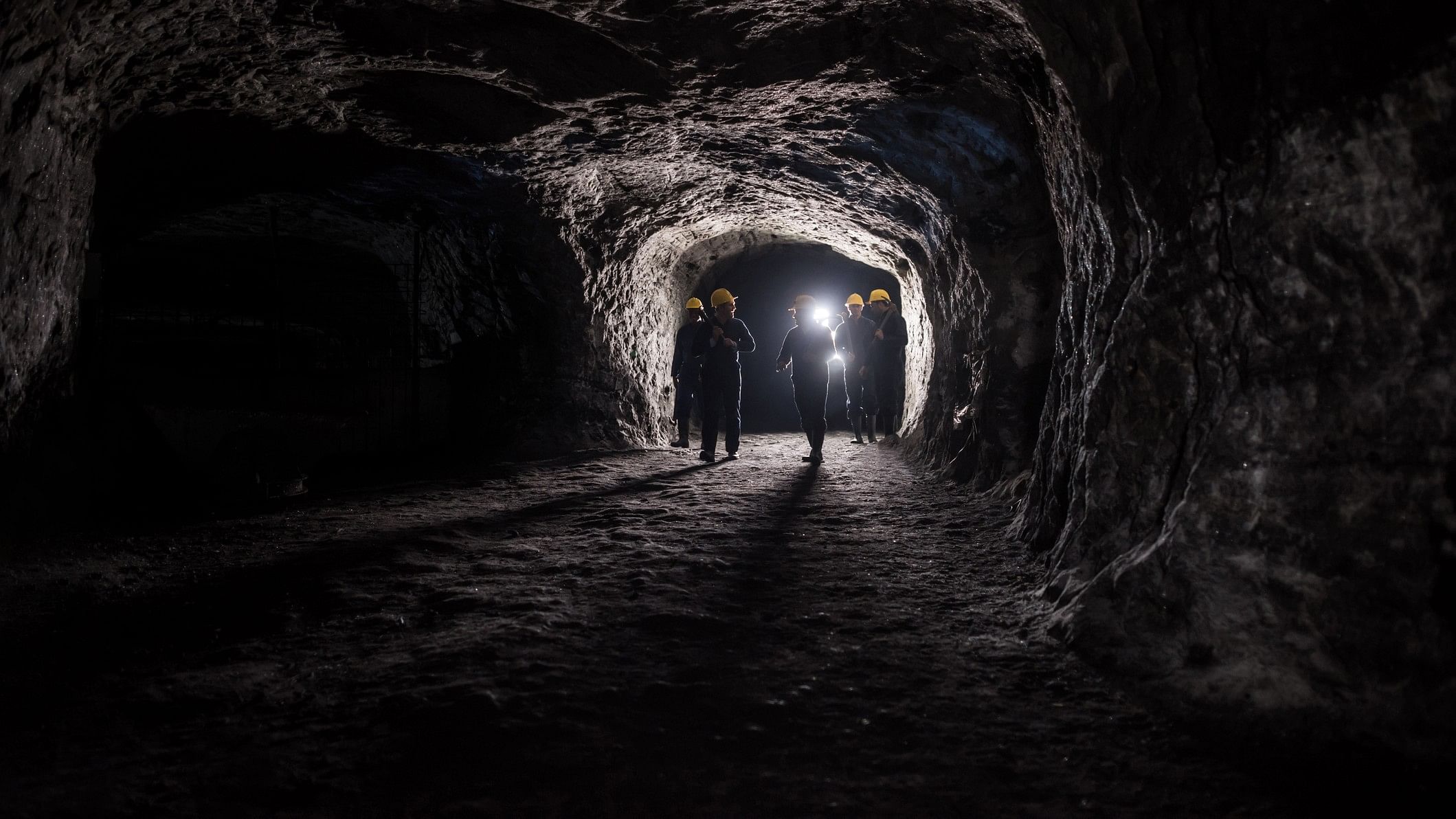 <div class="paragraphs"><p>Representative image showing group of men in a dark mine underground.</p></div>
