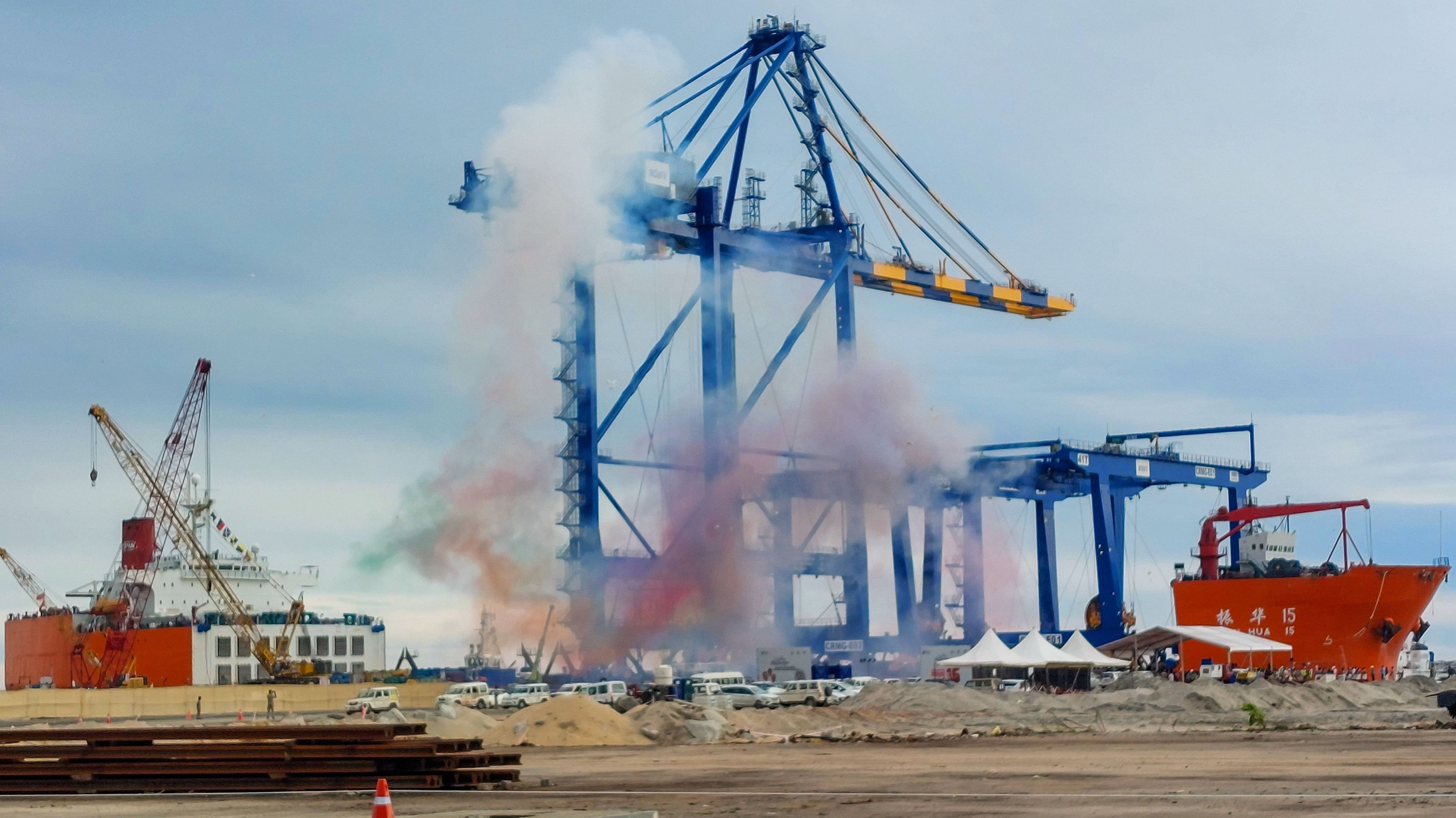 <div class="paragraphs"><p>Coloured fumes rise in the sky as the first ship carrying port equipment given an official reception at Vizhinjam International Seaport Limited, in Thiruvananthapuram, October 15, 2023. </p></div>