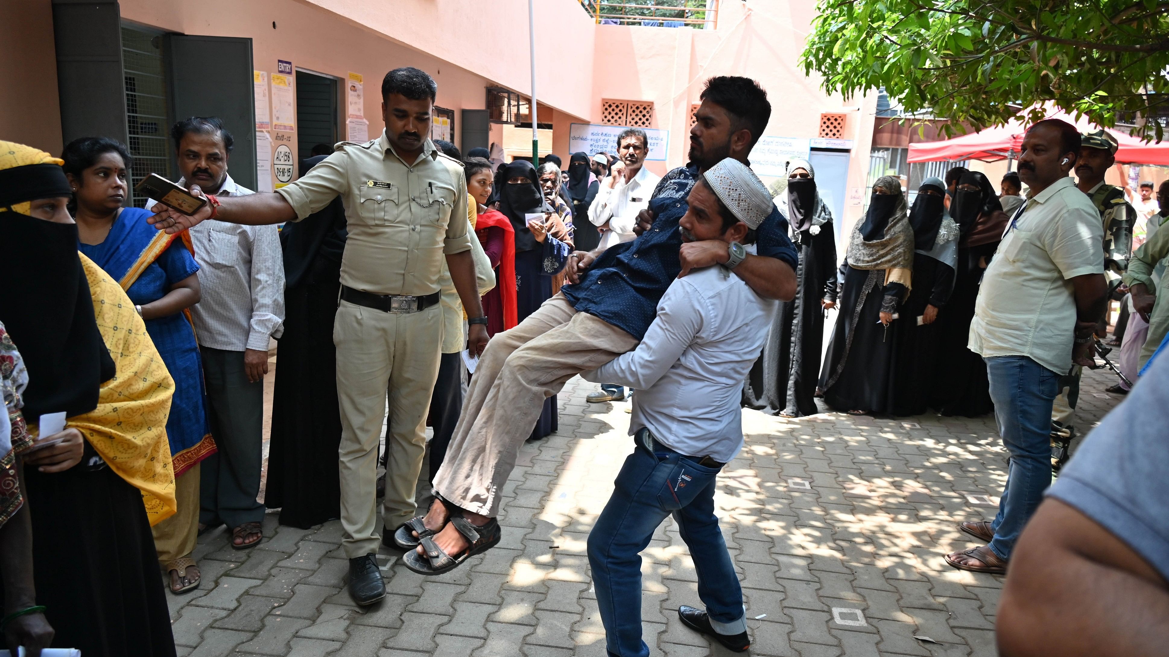 <div class="paragraphs"><p>A person with disability is carried to a polling station to cast his vote in the 2023 Karnataka Assembly election in Bengaluru. </p></div>