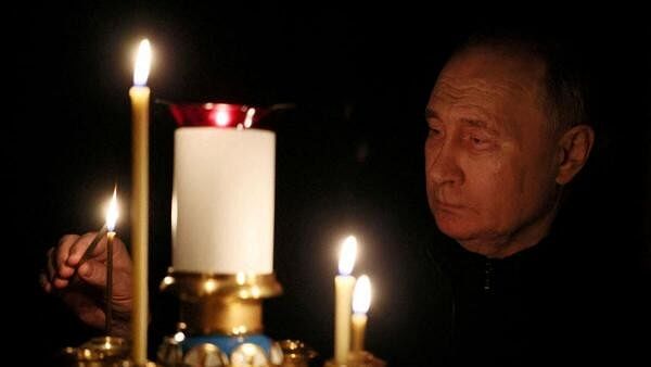 <div class="paragraphs"><p>Russian President Vladimir Putin lights a candle in memory of the victims of the Crocus City Hall attack, on the day of national mourning in a church at the Novo-Ogaryovo state residence outside Moscow, Russia March 24, 2024.</p></div>