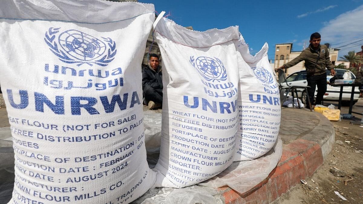 <div class="paragraphs"><p>Displaced Palestinians wait to receive United Nations Relief and Works Agency (UNRWA) aid</p></div>