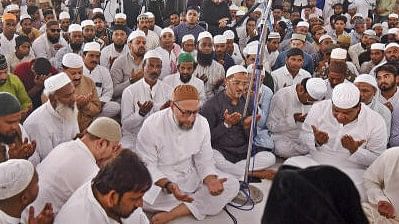 <div class="paragraphs"><p>All India Majlis-e-Ittehadul Muslimeen (AIMIM) chief Asaduddin Owaisi with others offer prayers at Mecca Masjid on the first Friday of the Holy month of Ramadan, in Hyderabad, Friday, March 15, 2024. </p></div>