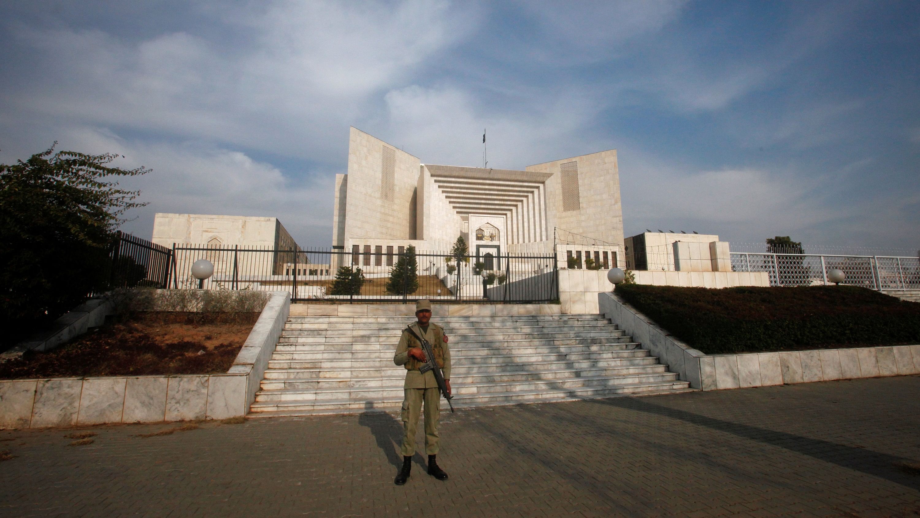 <div class="paragraphs"><p>A paramilitary soldier keeps guard outside the Supreme Court building in Islamabad, Pakistan February 9, 2012. </p></div>