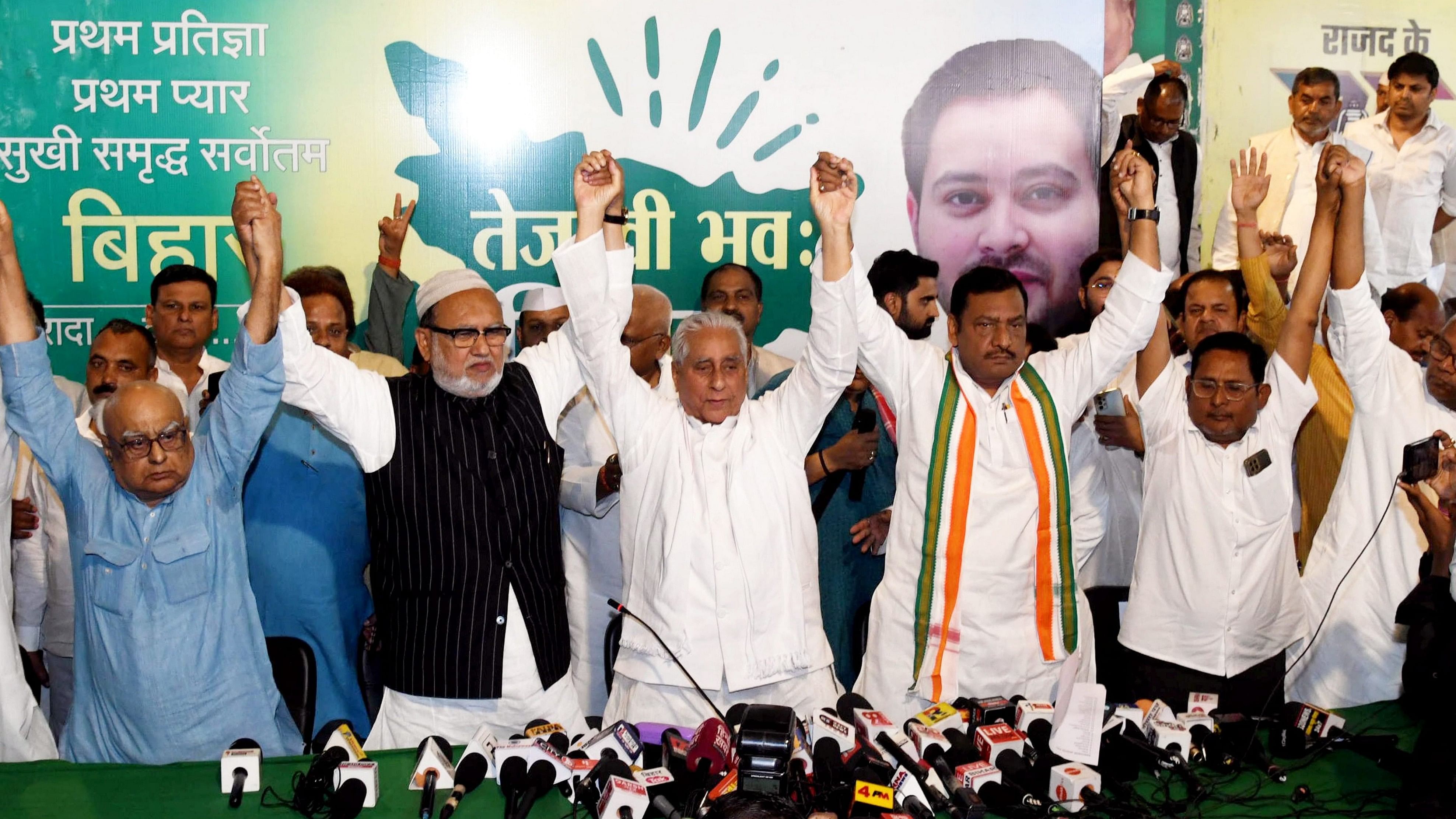 <div class="paragraphs"><p>Bihar RJD President Jagdanand Singh and State Congress President Akhilesh Singh join hands with CPI-ML, CPM and other leaders after releasing Grand Alliance candidates' list for Lok Sabha elections, in Patna, Friday, March 29, 2024. </p></div>