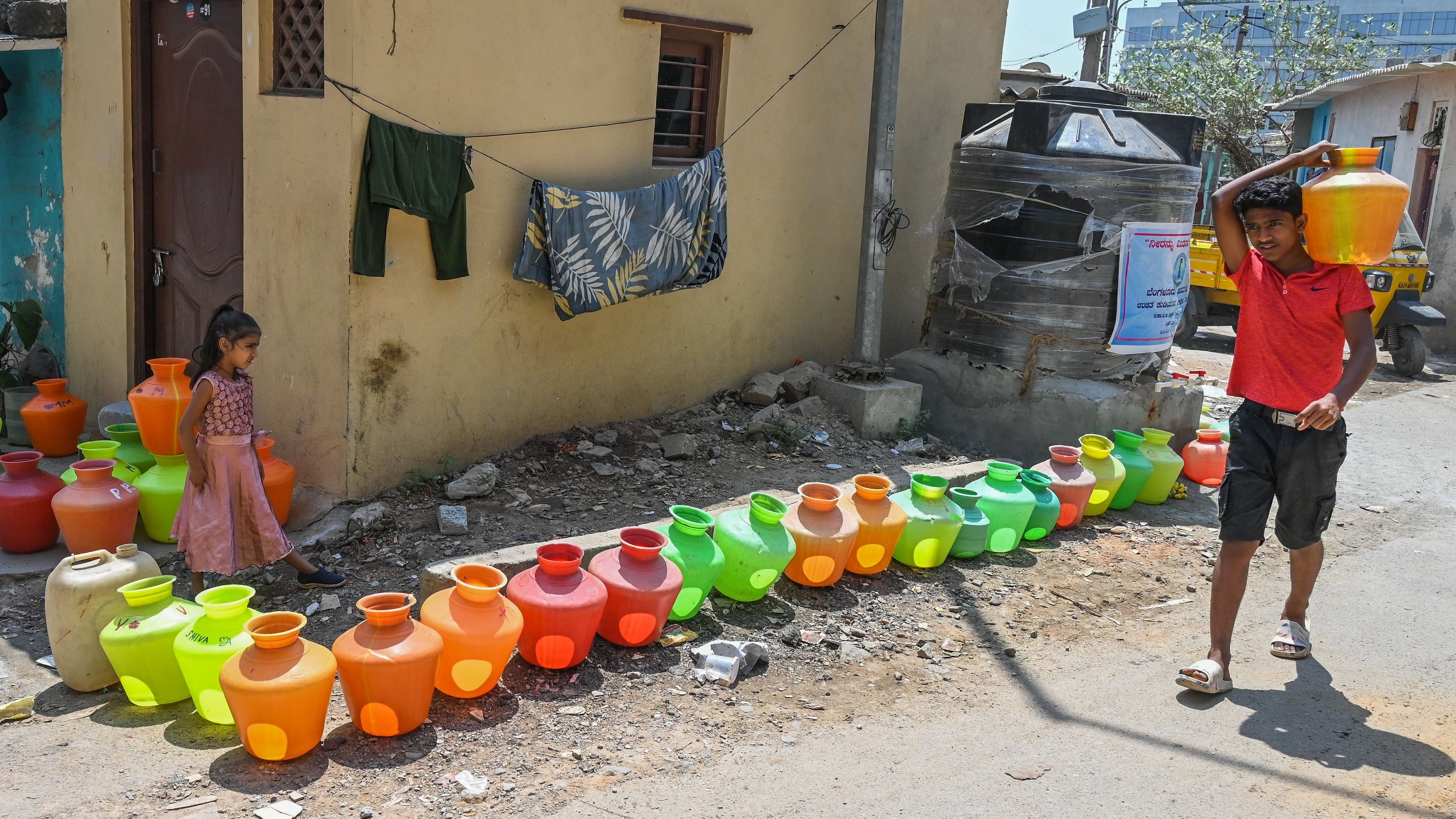 <div class="paragraphs"><p>Residents line up plastic pots to collect free Cauvery drinking water at NS Palya on Thursday.&nbsp;&nbsp;</p></div>