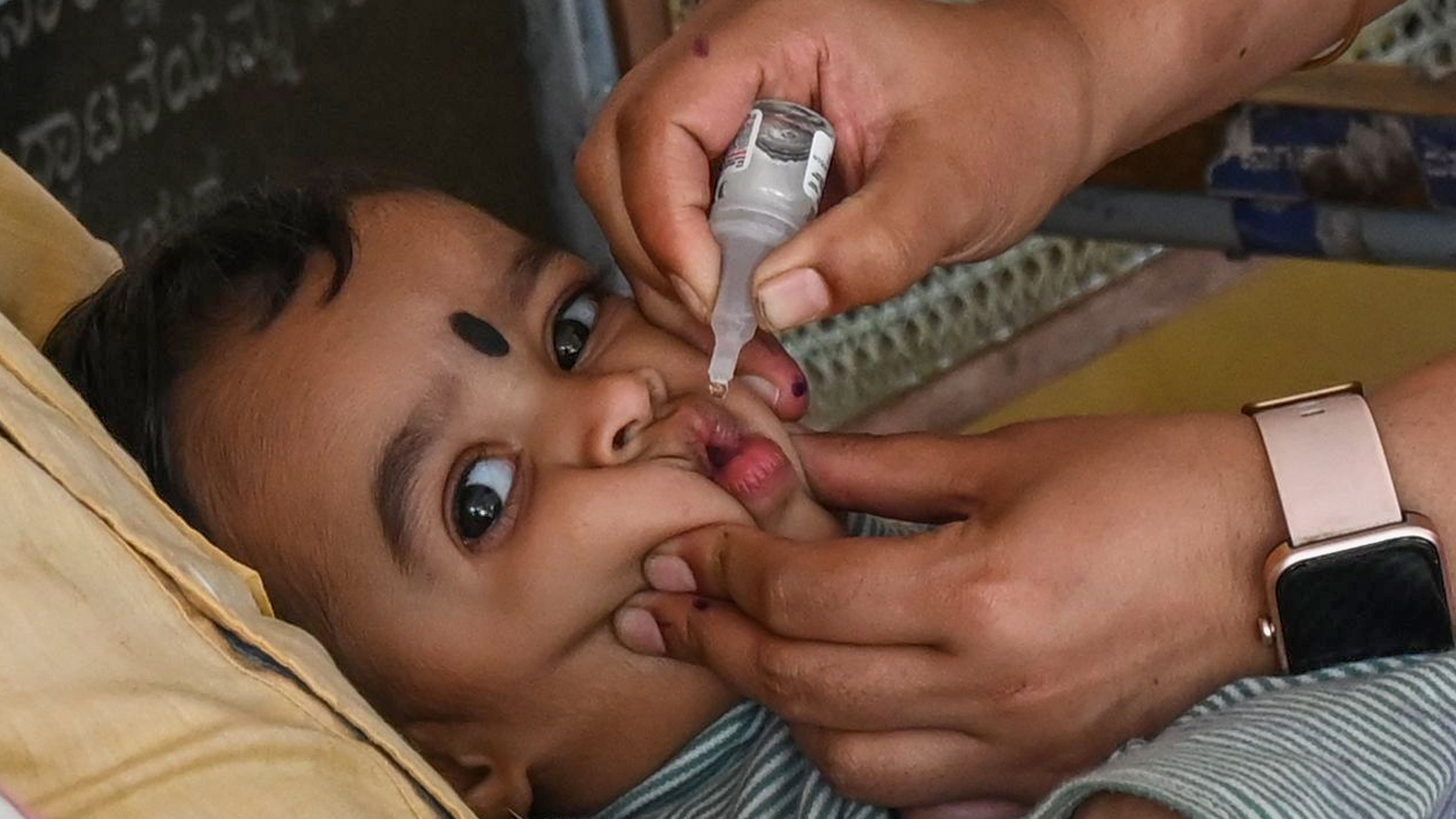 <div class="paragraphs"><p>A health worker administers polio drops to a child at the Primary Health Centre on Sunday.&nbsp;</p></div>