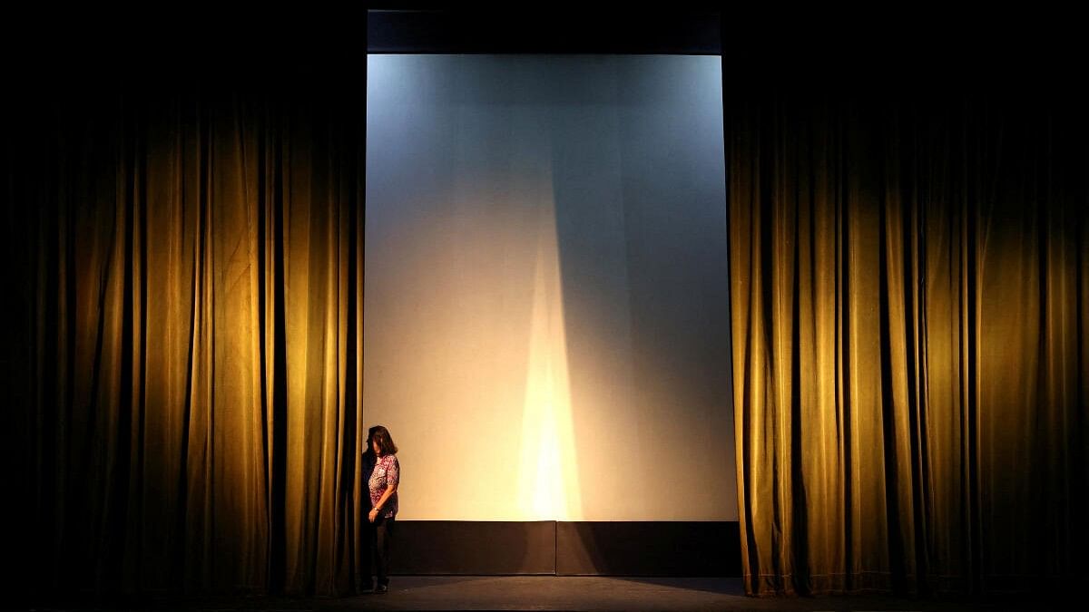 <div class="paragraphs"><p>A woman prepares the vintage 'Normandie' movie theater before the start of a movie presentation, in Santiago, Chile.</p></div>