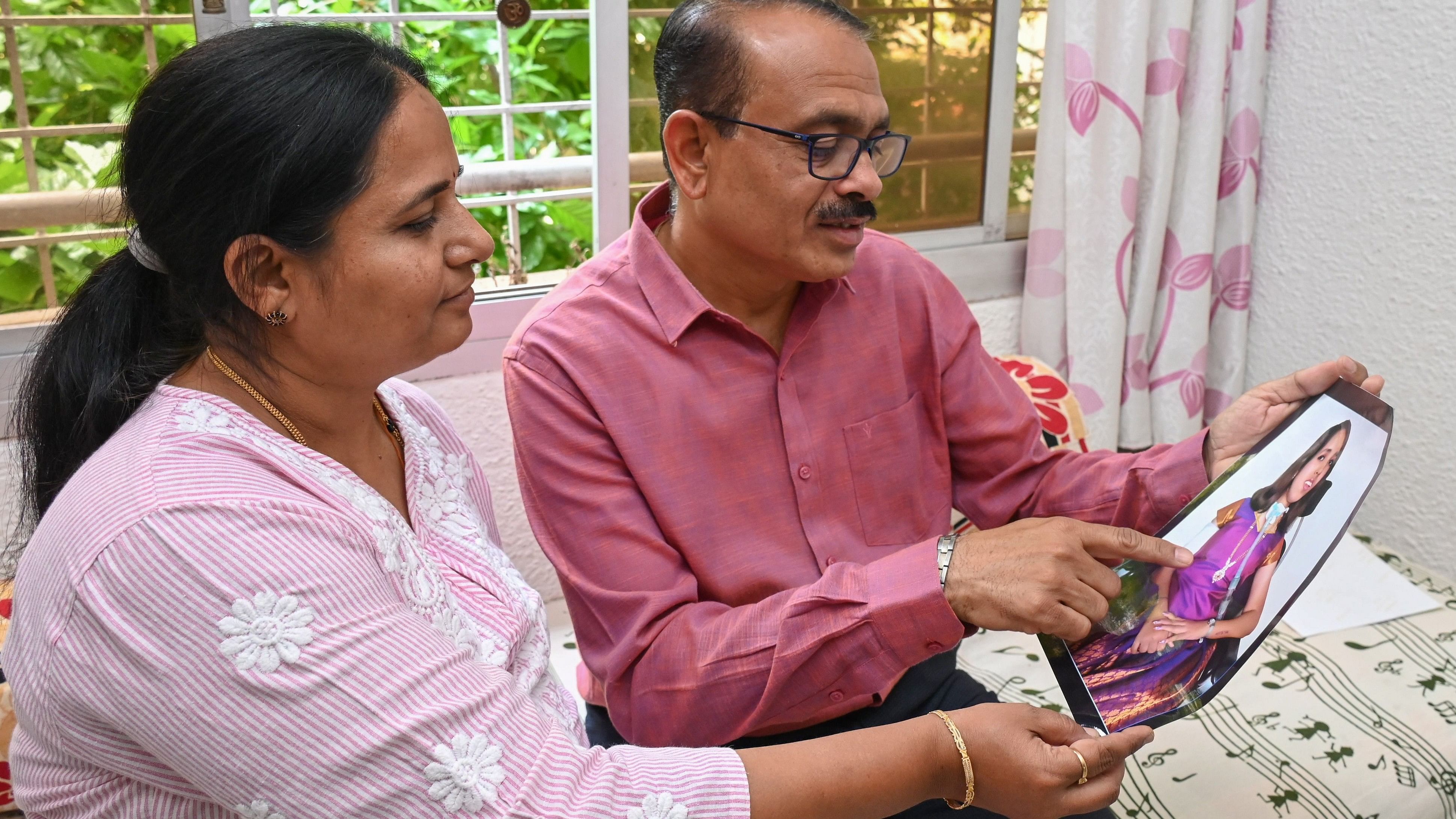 <div class="paragraphs"><p>Prasanna and Sharada Shirol with the photo of their daughter Nidhi, who passed away last year.</p></div>