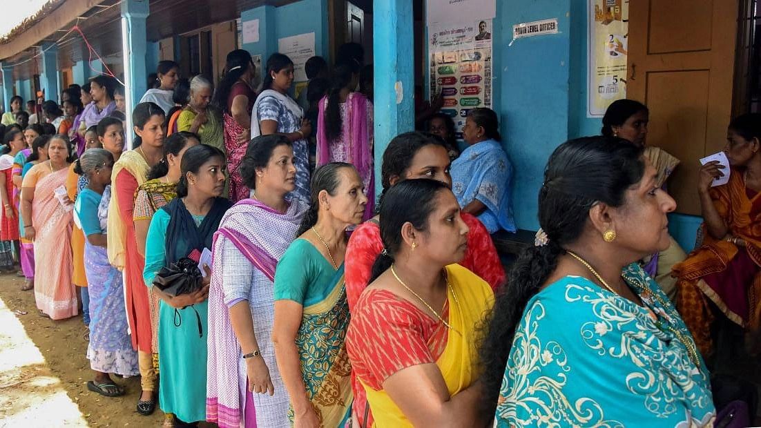 <div class="paragraphs"><p>Voters queue up to cast their votes at a polling station.</p></div>