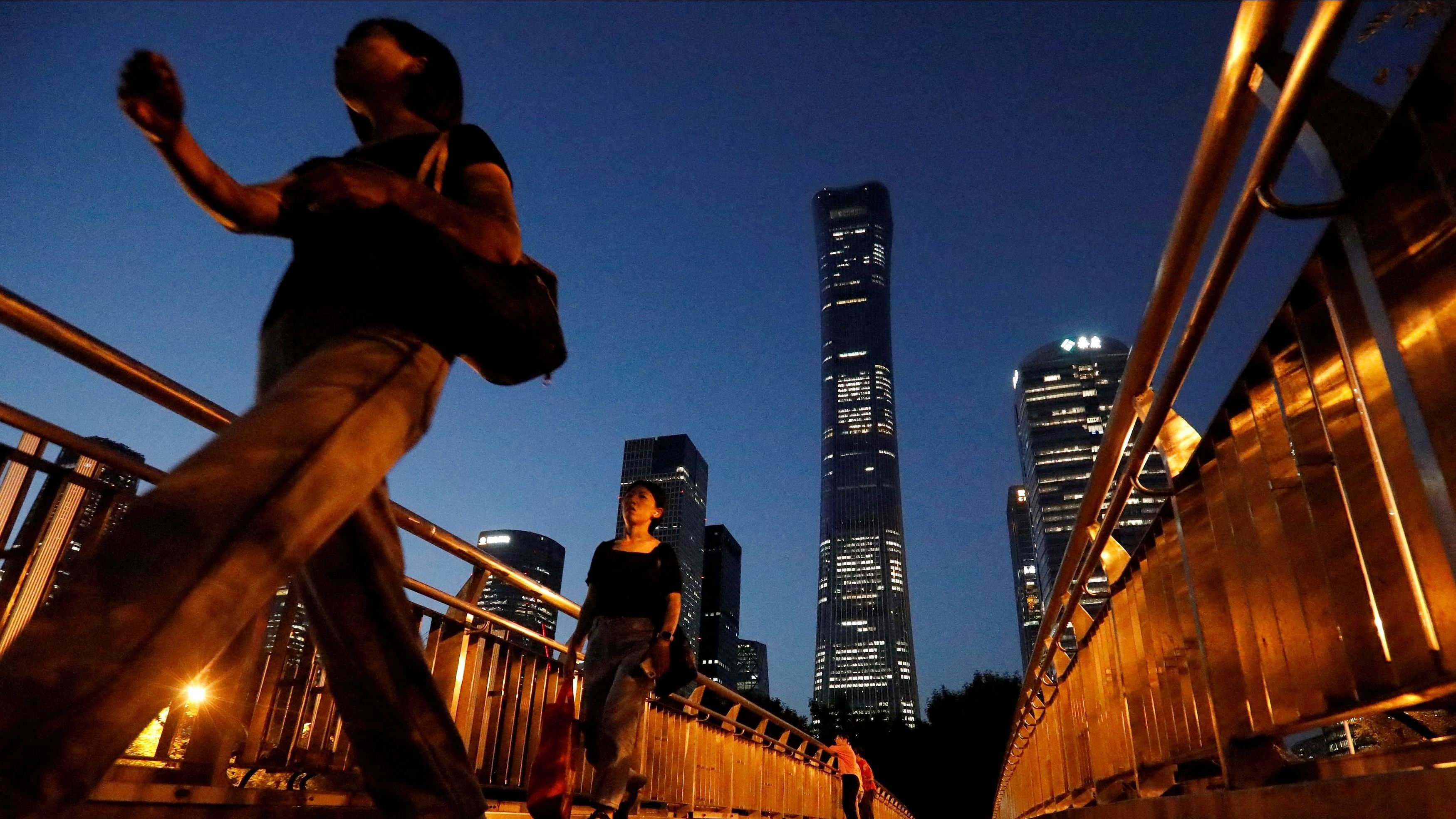 <div class="paragraphs"><p> Pedestrians walk on an overpass near skyscrapers at the  Central Business District  in Beijing, China August 21, 2023. </p></div>