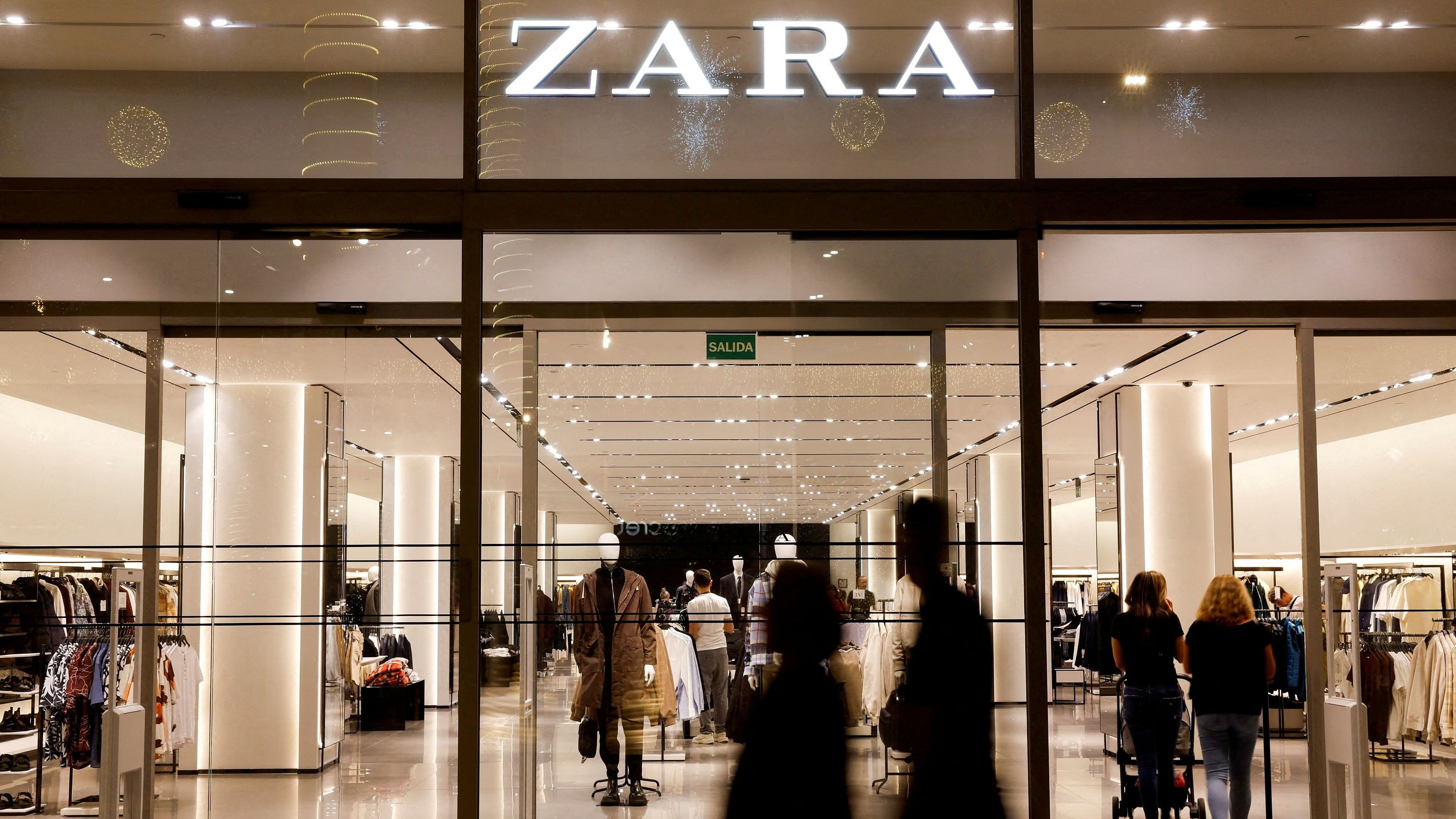 <div class="paragraphs"><p>Shoppers walk past a Zara clothes store in Spain.</p></div>