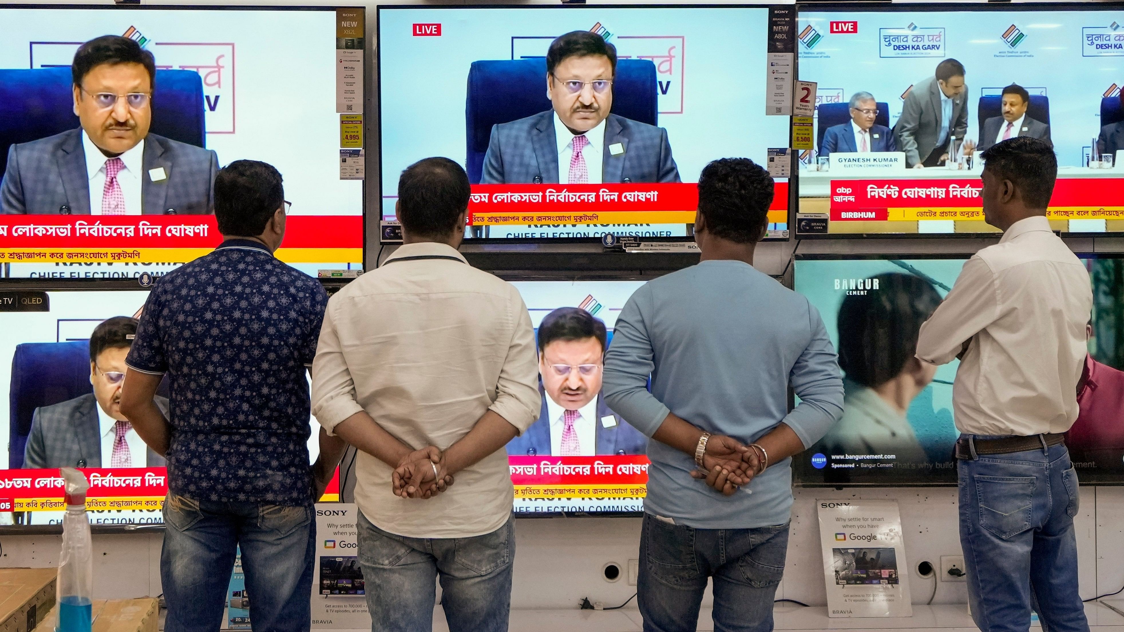 <div class="paragraphs"><p>Kolkata: People watch live telecast of the Election Commission of India's press conference for the announcement of the schedule of Lok Sabha elections, at a TV showroom in Kolkata, Saturday, March 16, 2024. </p></div>