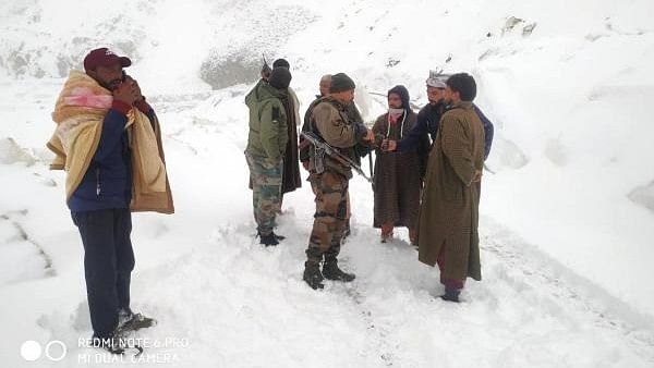 <div class="paragraphs"><p>Indian Army soldiers speak to stranded civilians after heavy snowfall. Representative image. </p></div>