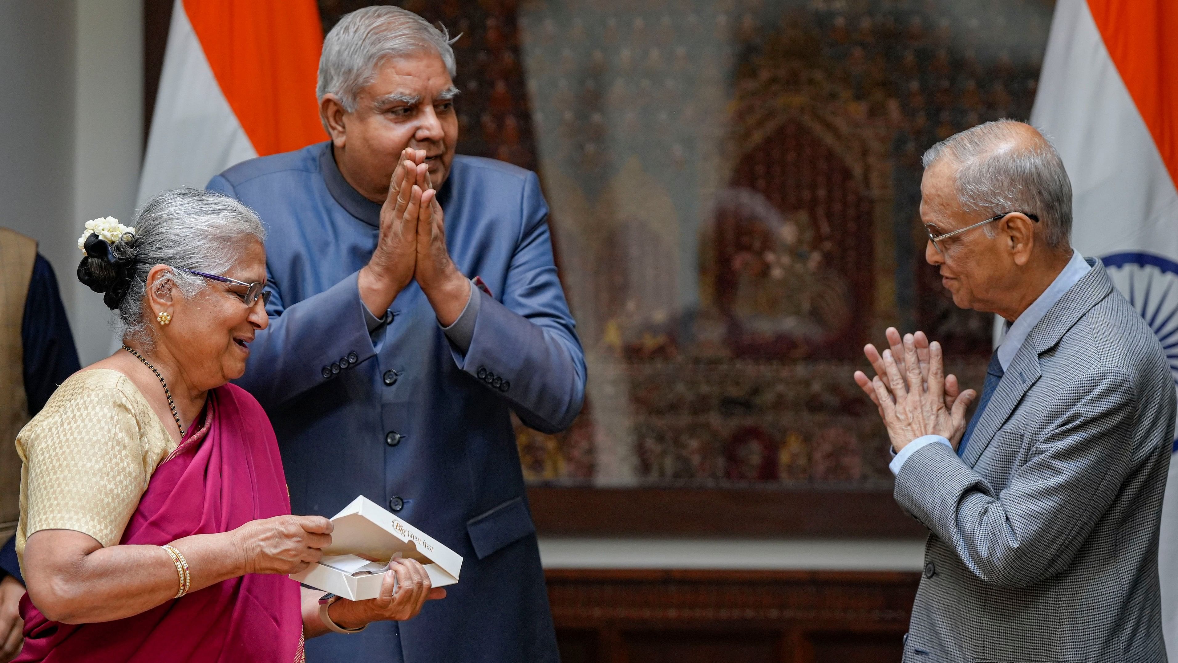 <div class="paragraphs"><p>Philanthropist and author Sudha Murty offers sweet to Rajya Sabha Chairman Jagdeep Dhankhar and Infosys co-founder N R Narayana Murthy after taking oath as Rajya Sabha MP, at Parliament House in New Delhi.</p></div>