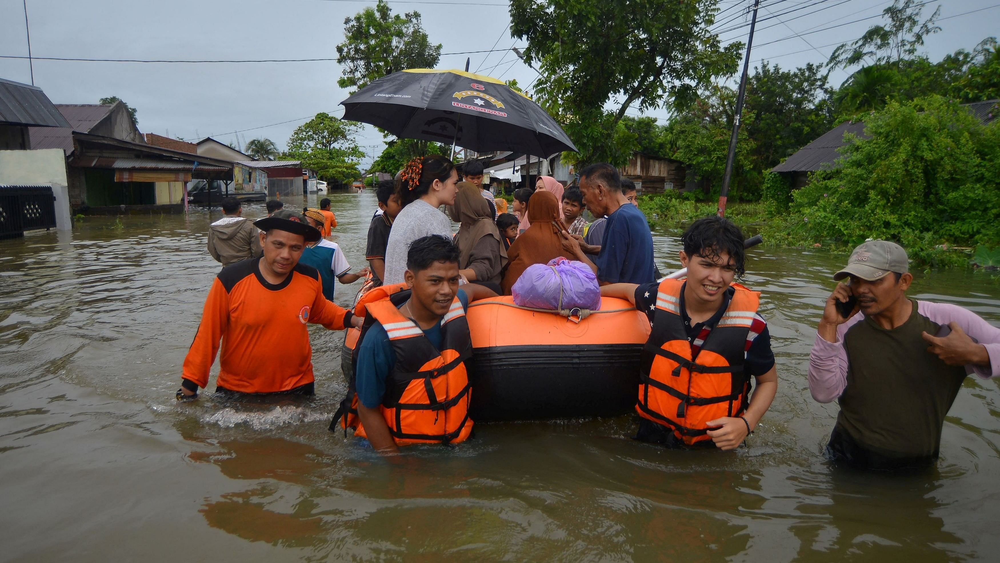 <div class="paragraphs"><p>Local Disaster Management Agency  officers use an inflatable boat to evacuate locals at a residential area affected by floods due to heavy rains, in Padang.</p></div>