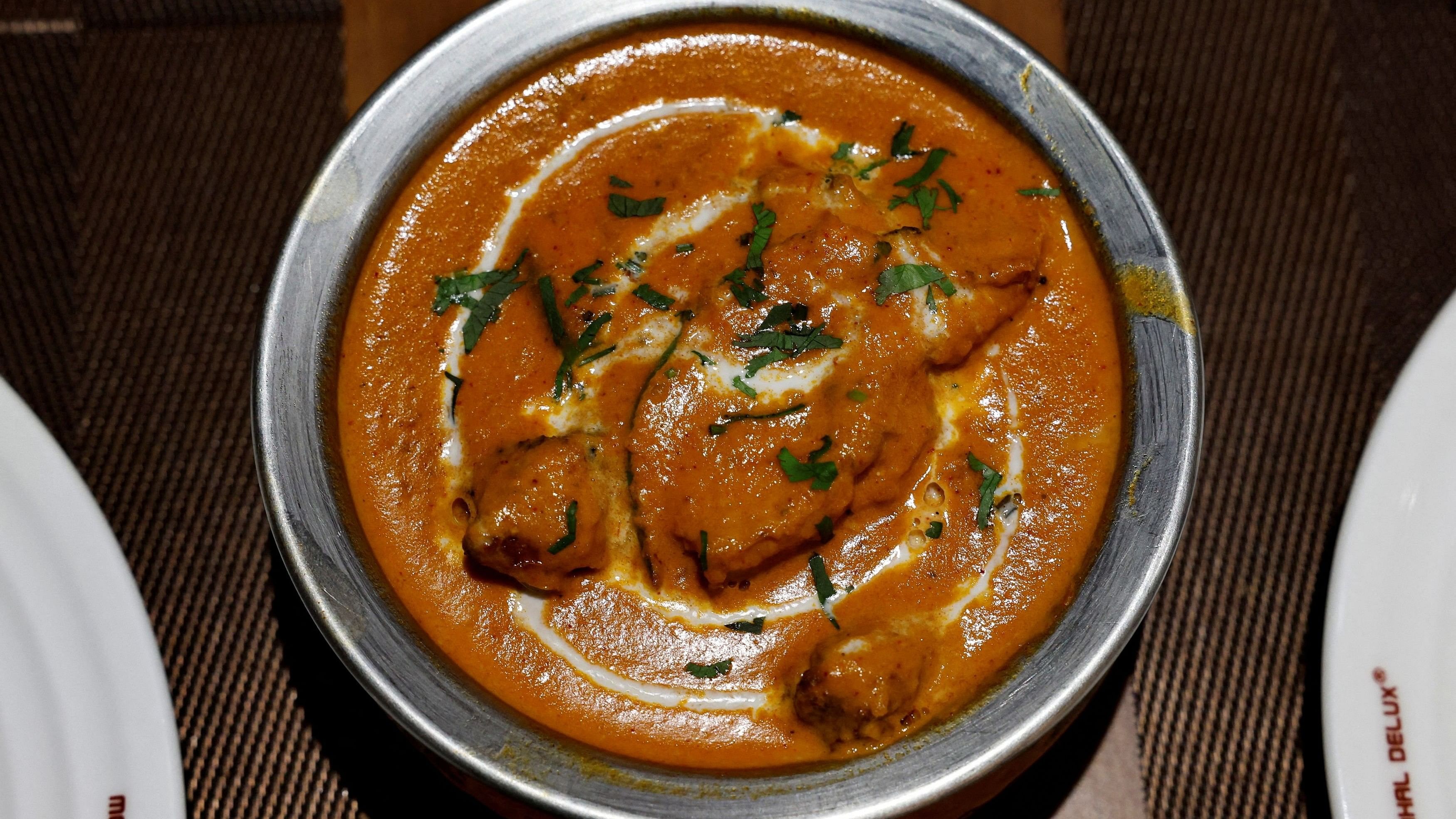 <div class="paragraphs"><p>A freshly prepared butter chicken dish placed on a table.</p></div>