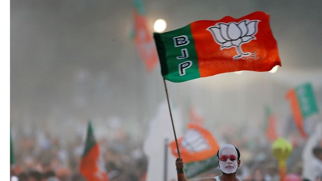 <div class="paragraphs"><p>Representative image of BJP supporters waving a party flag.  </p></div>