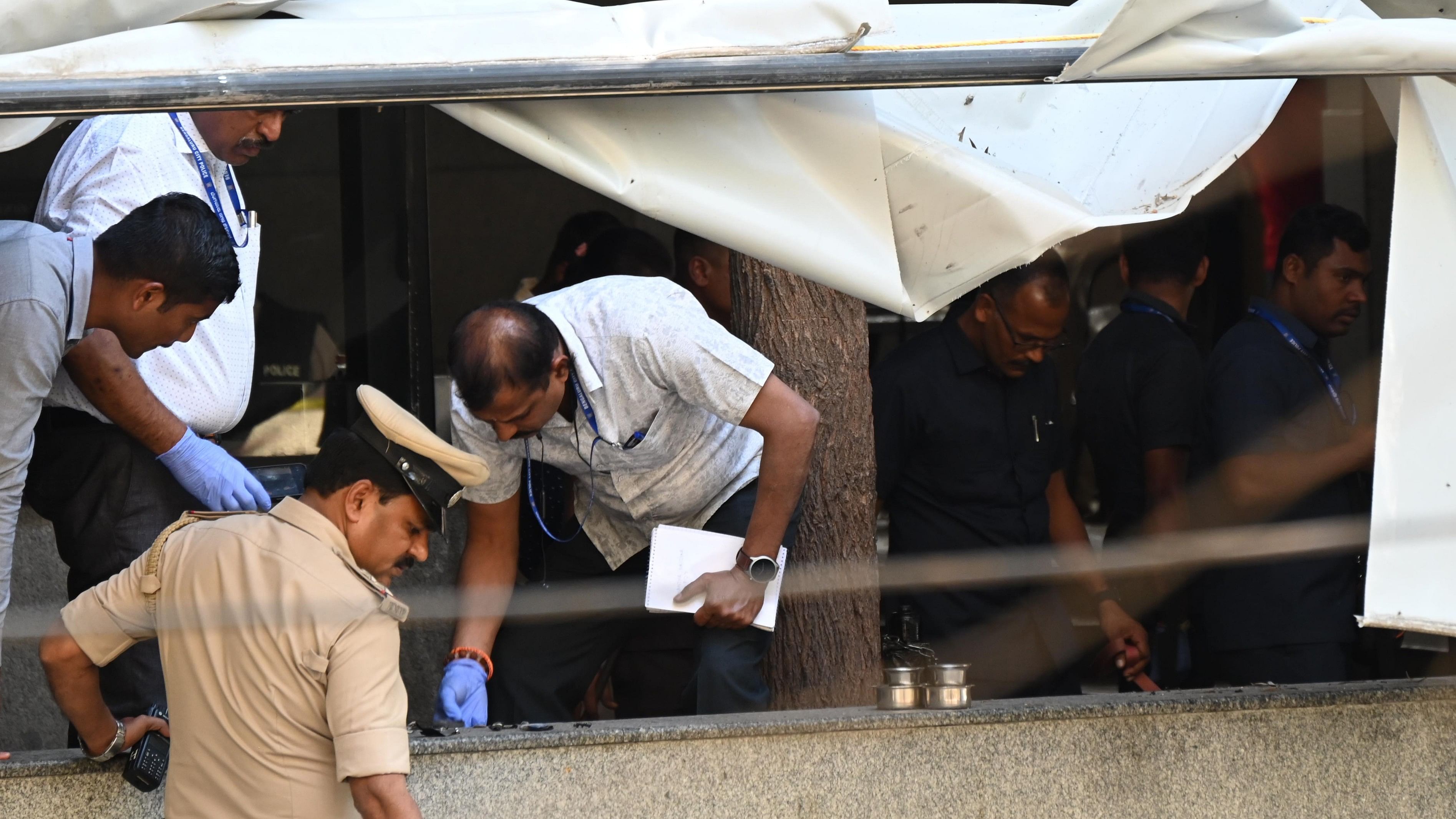 <div class="paragraphs"><p>Police, Bomb detection &amp; disposal squad examining the spot where an explosion occurred at The Rameshwaram Cafe at Whitefield in Bengaluru on Friday.</p></div>