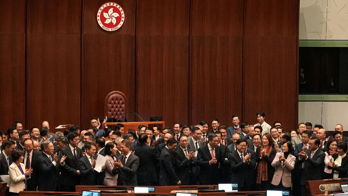 <div class="paragraphs"><p>Hong Kong Chief Executive John Lee, government officials and lawmakers applaud following a group photo, after the Safeguarding National Security Bill, also referred to as Basic Law Article 23, was passed at the Hong Kong’s Legislative Council, in Hong Kong, China March 19, 2024.</p></div>