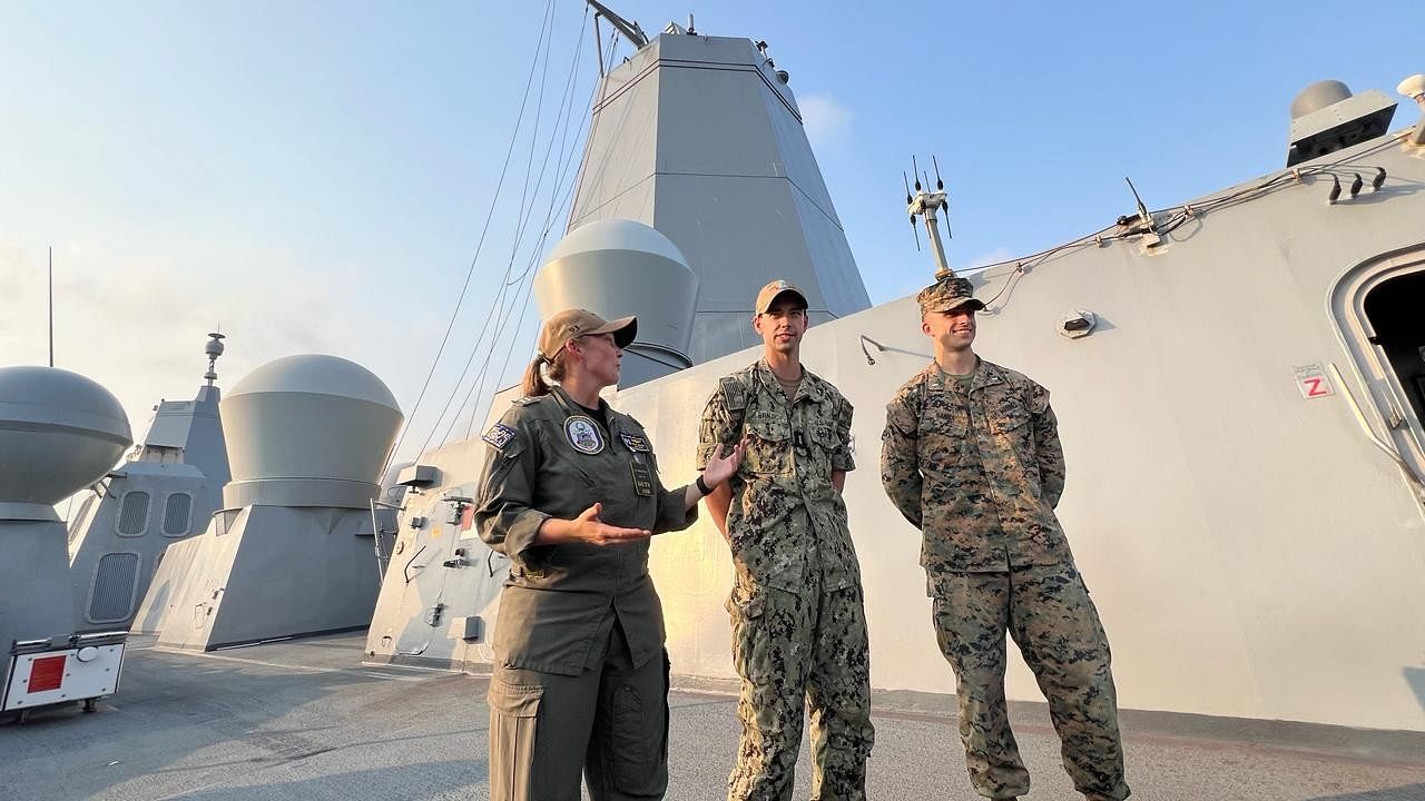 <div class="paragraphs"><p>Naval and marine officers of USS Somerset explaining the features of the ship and its capacity for the landing of aircraft and choppers.</p></div>