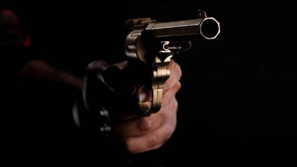 <div class="paragraphs"><p>Image of a person holding a gun.</p></div>