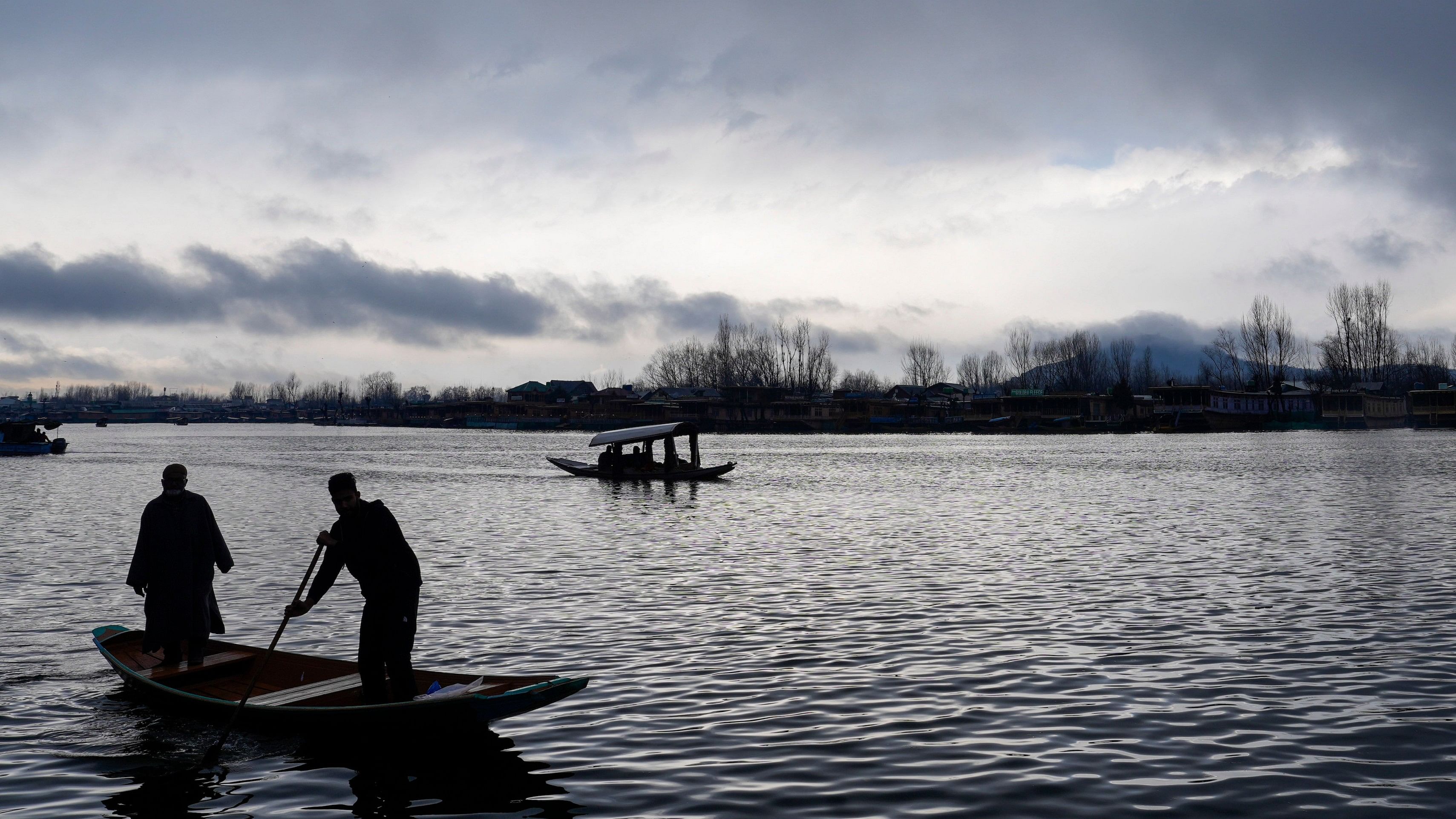 <div class="paragraphs"><p>Boatmen cross the Dal Lake amid rains, in Srinagar, March 2, 2024. Several areas in the higher reaches of Jammu and Kashmir received fresh snowfall while the plains were lashed by rain.</p></div>