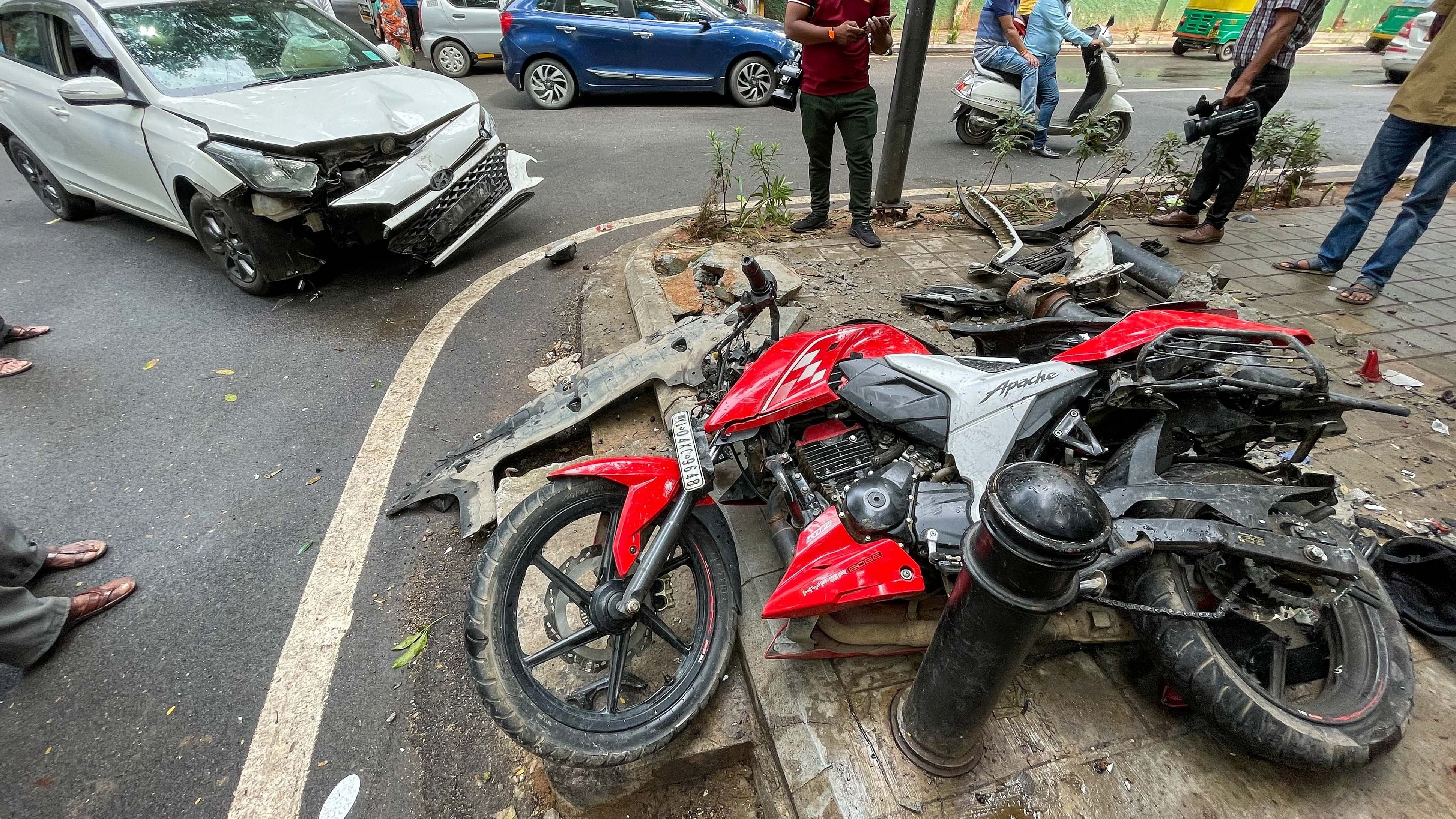 <div class="paragraphs"><p>A speeding car collides with a motorbike on Ali Askar road, Bengaluru on Sunday knocking down the TenderSure boulders. Locals claim that the car belongs to a former BBMP corporator. All involved in the accident were been hospitalised.</p></div>