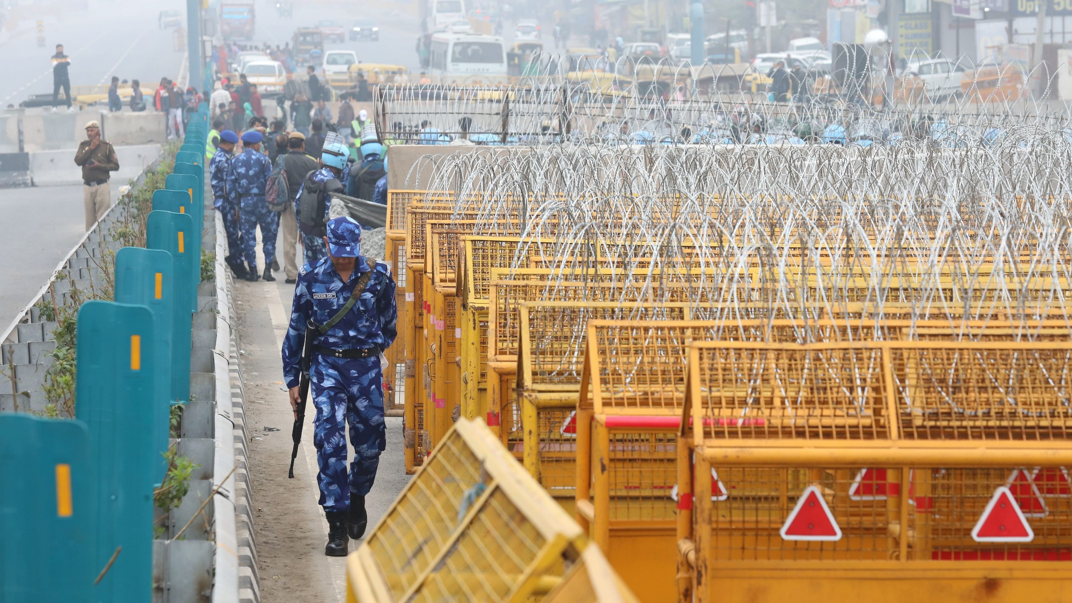 <div class="paragraphs"><p>Police and security personnel keep a vigil near multi-layered barricading at the Singhu Border, in New Delhi.</p></div>