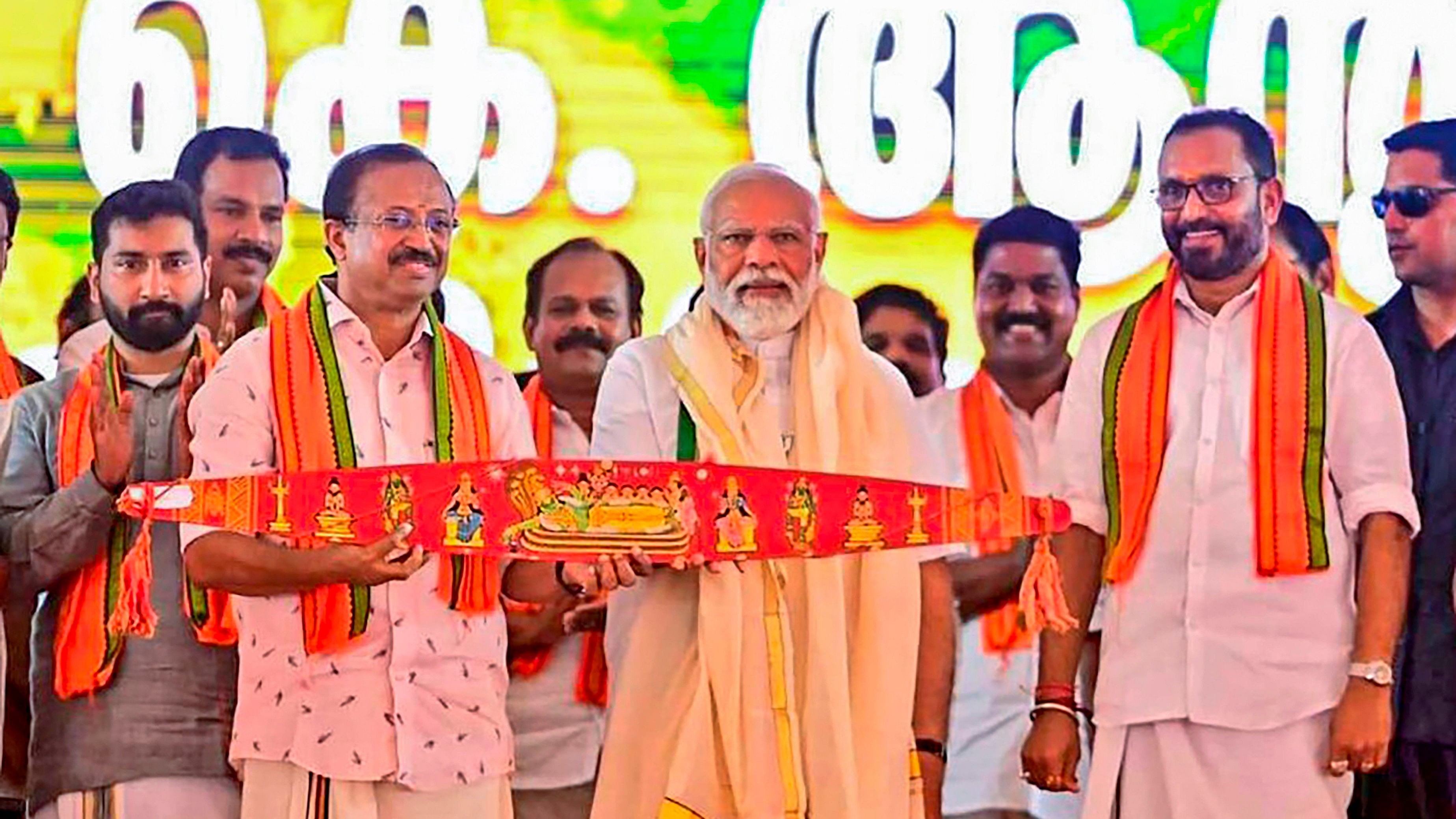 <div class="paragraphs"><p>Prime Minister Narendra Modi being presented the traditional Onavillu by Union Minister of State V Muraleedharan during a public meeting in Pathanamthitta, Friday, March 15, 2024. </p></div>