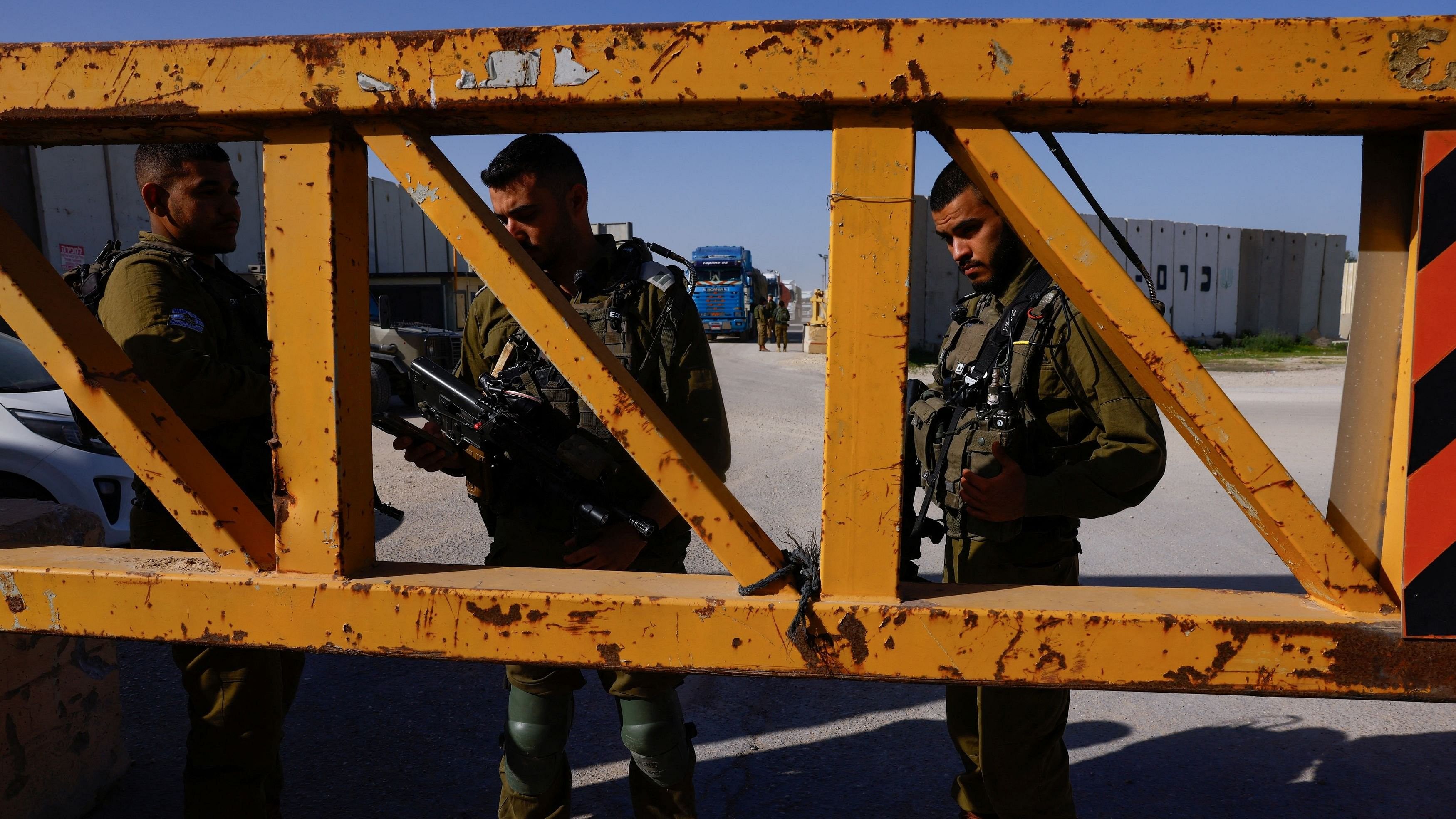 <div class="paragraphs"><p>File Photo: Members of the Israeli military stand at the entrance as an aid truck enters from Egypt, en route to Gaza, amid the ongoing conflict between Israel and the Palestinian Islamist group Hamas, at the Kerem Shalom crossing, in Israel, December 22, 2023. </p></div>