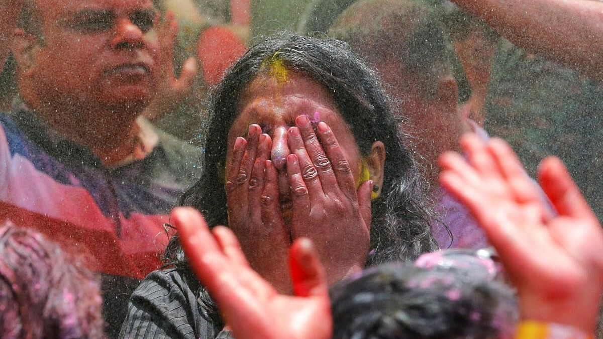 <div class="paragraphs"><p>A woman daubed with colour powders. Representative image for Holi celebration.&nbsp;</p></div>