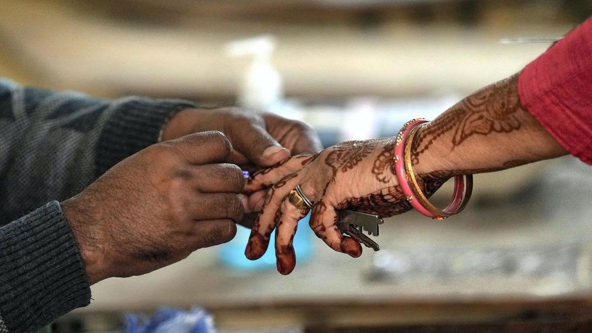 <div class="paragraphs"><p>A voter gets her finger marked with indelible ink before casting her vote.</p></div>