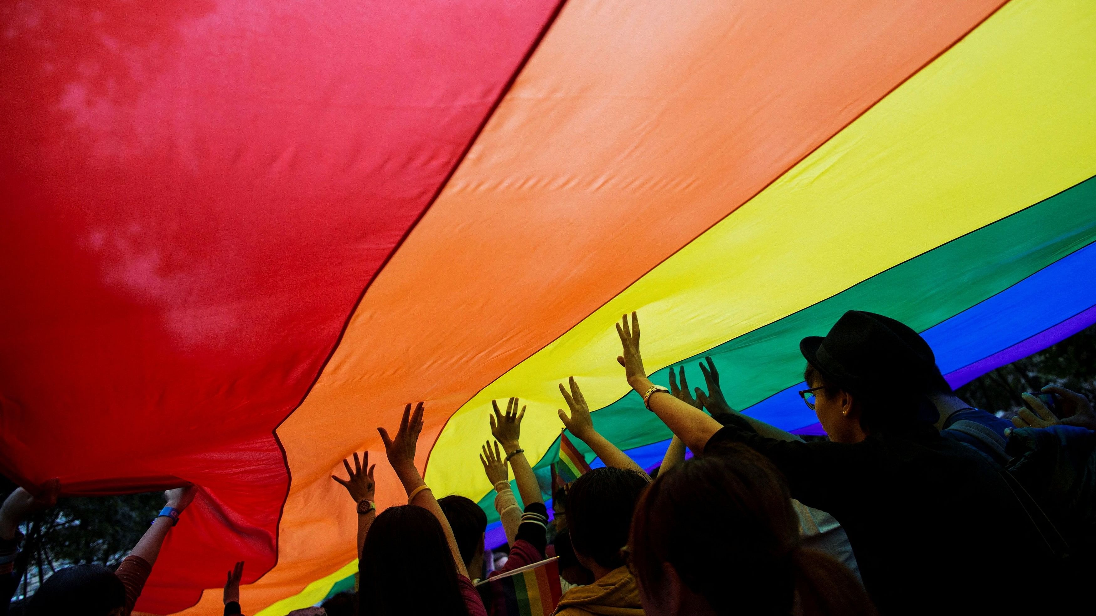 <div class="paragraphs"><p> Participants hold a giant rainbow flag during a lesbian, gay, bisexual and transgender  Pride Parade in Hong Kong November 8, 2014. </p></div>